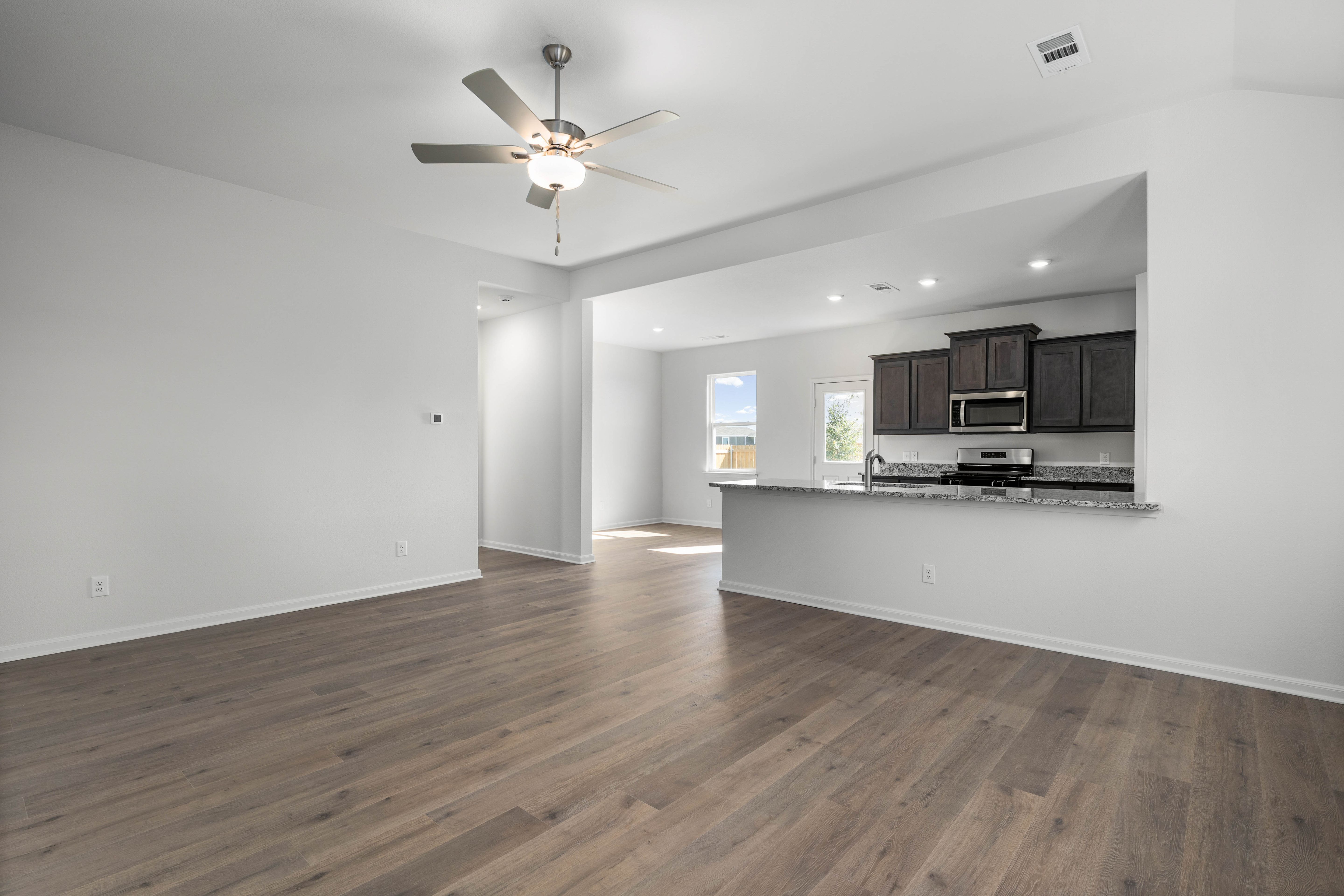 The kitchen, dining room and living room sit adjacent to one another.