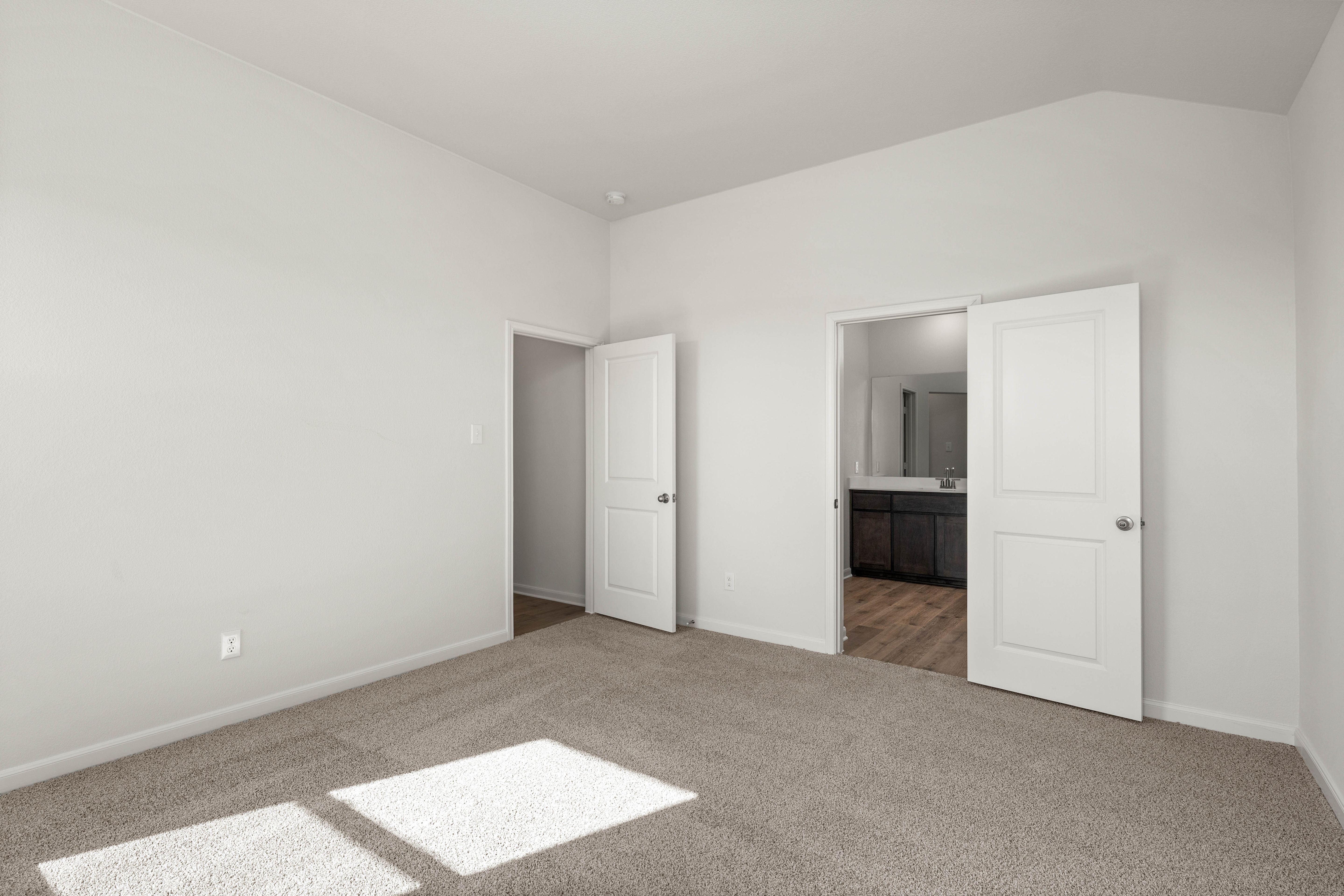 The master suite has a large bedroom, ensuite bathroom and a walk-in closet.