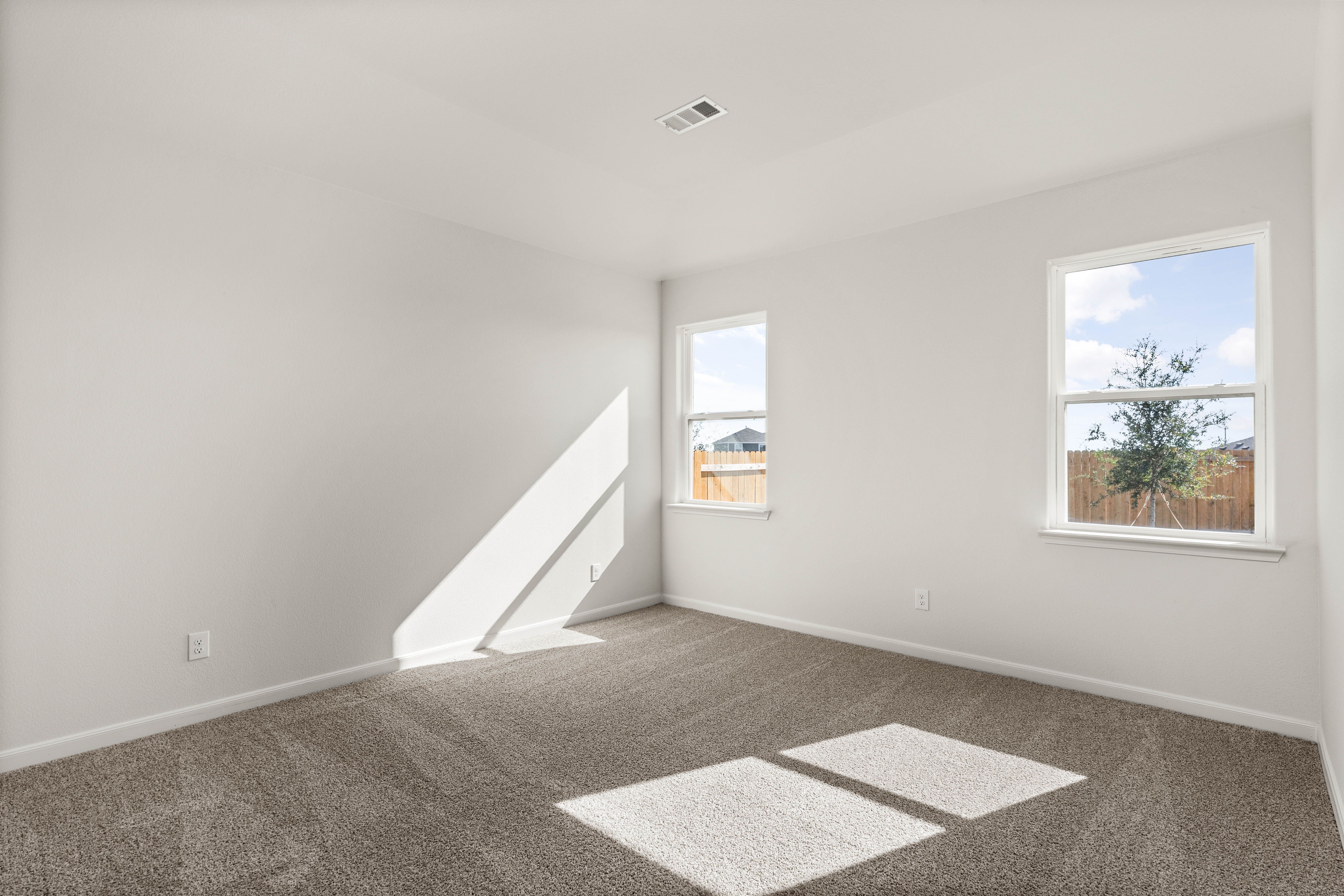The master bedroom has two large windows.