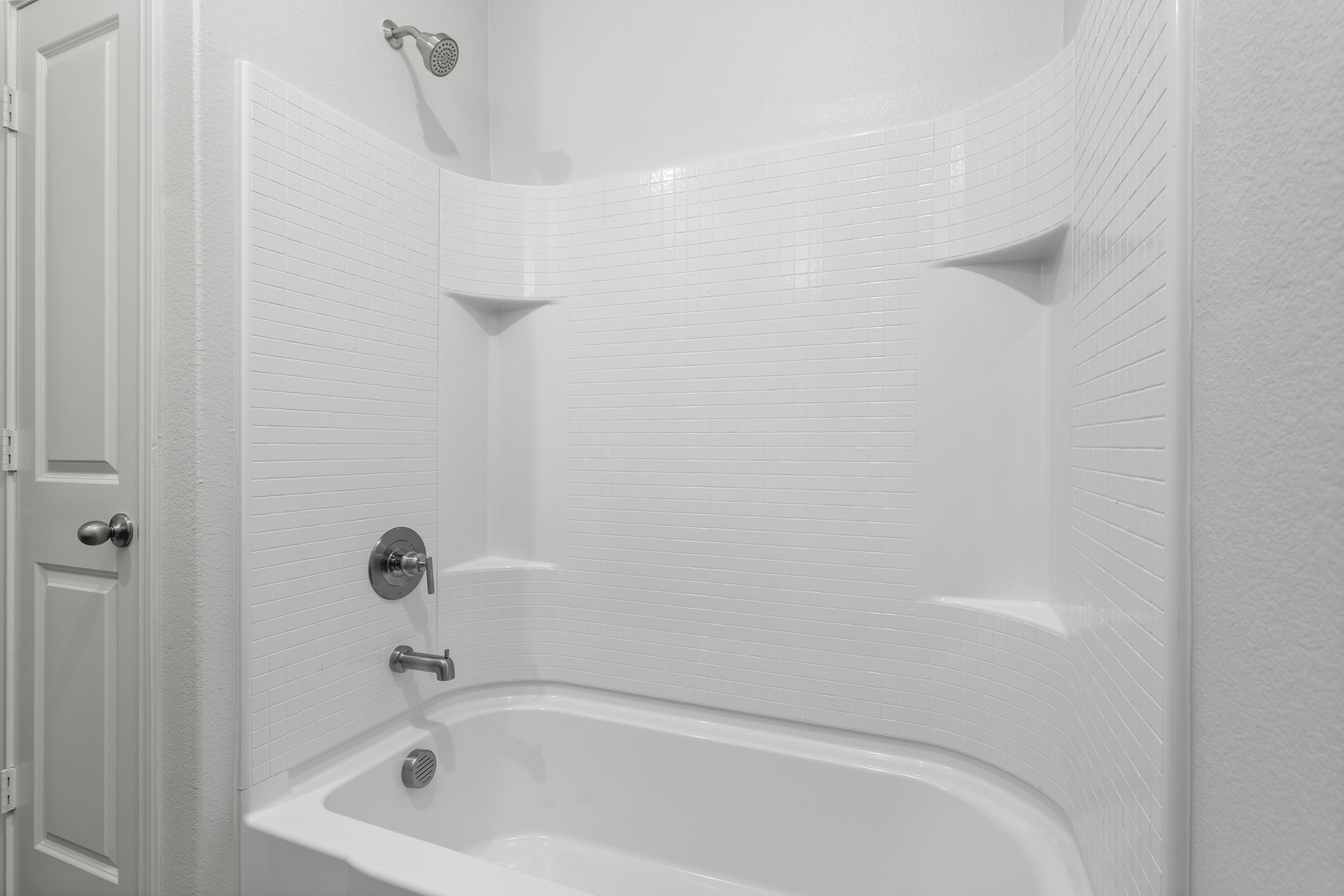 The secondary bathroom has a shower-tub combo.