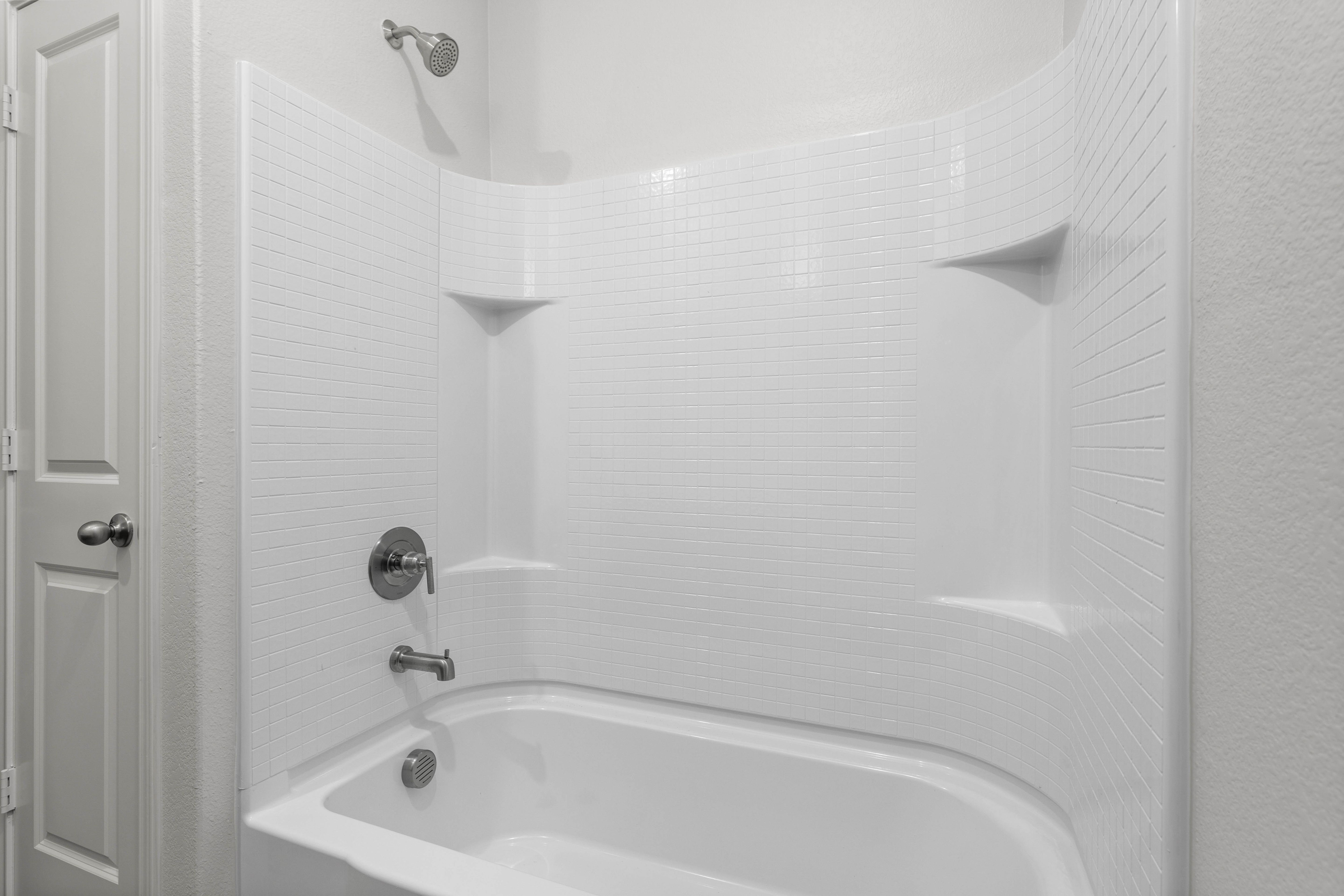 The secondary bathroom has a shower-tub combo.
