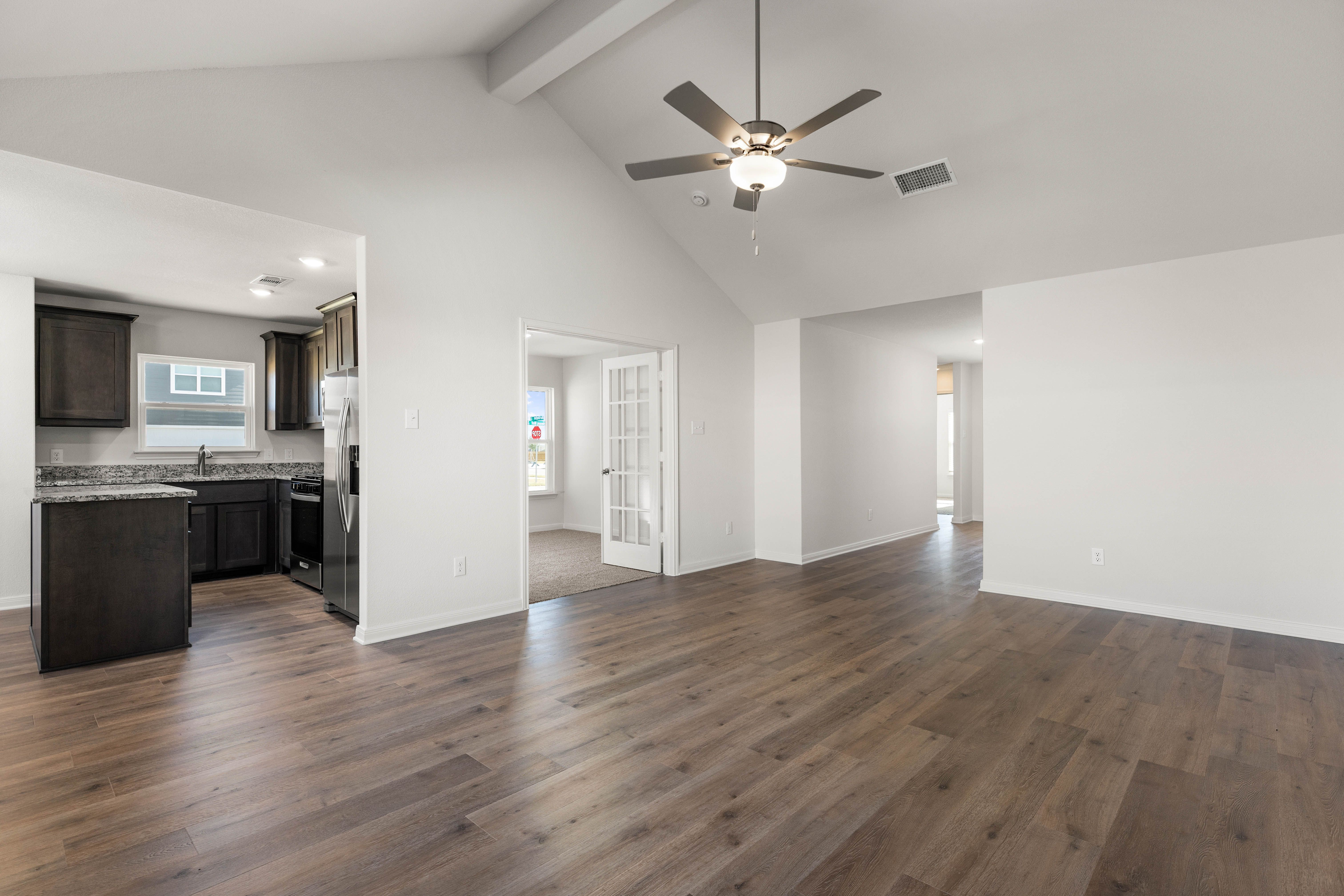 The kitchen, dining room and living sit adjacent to another.