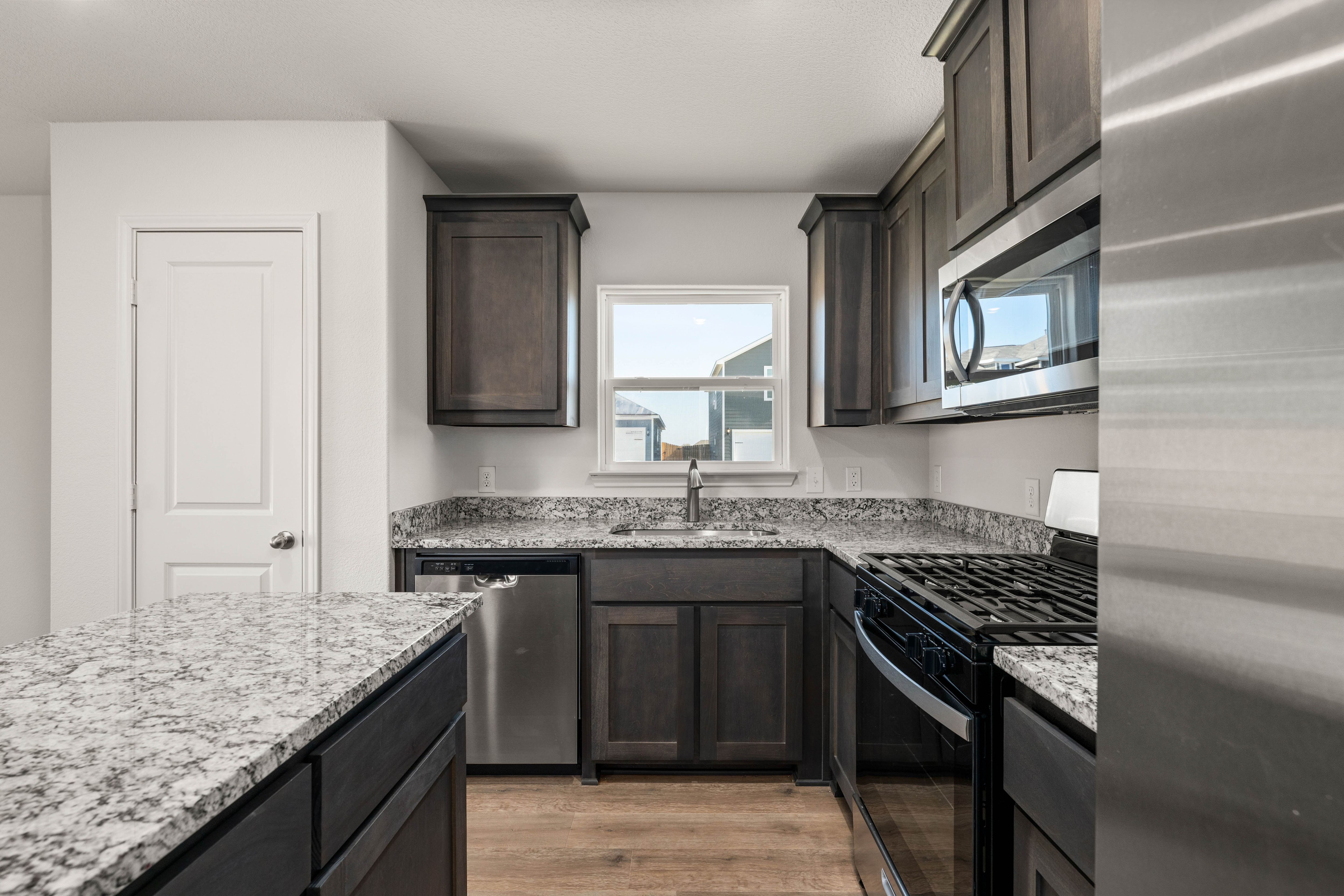 The kitchen of the Sabine has beautiful wood cabinetry.