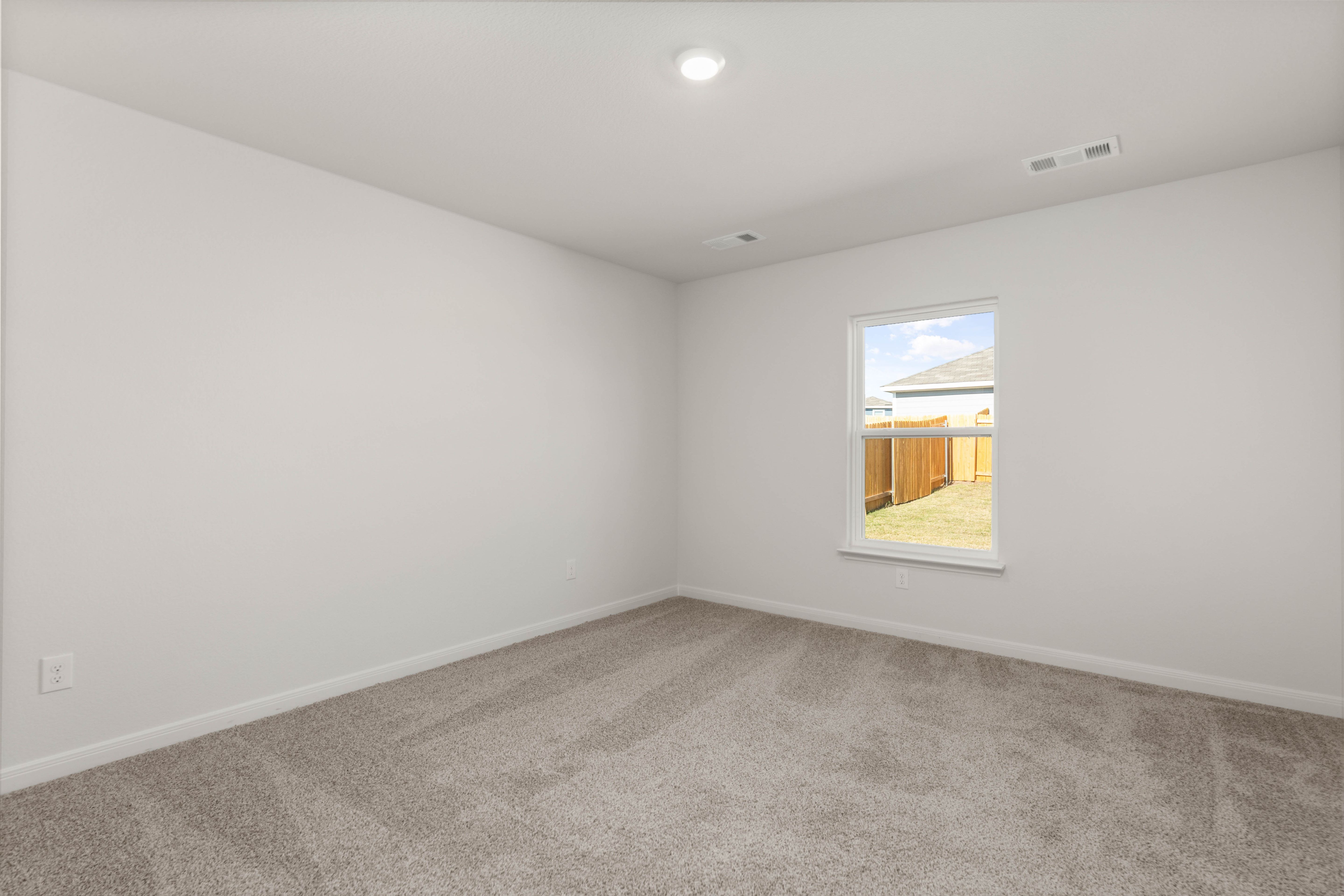 The master bedrooms is spacious and has a large window.