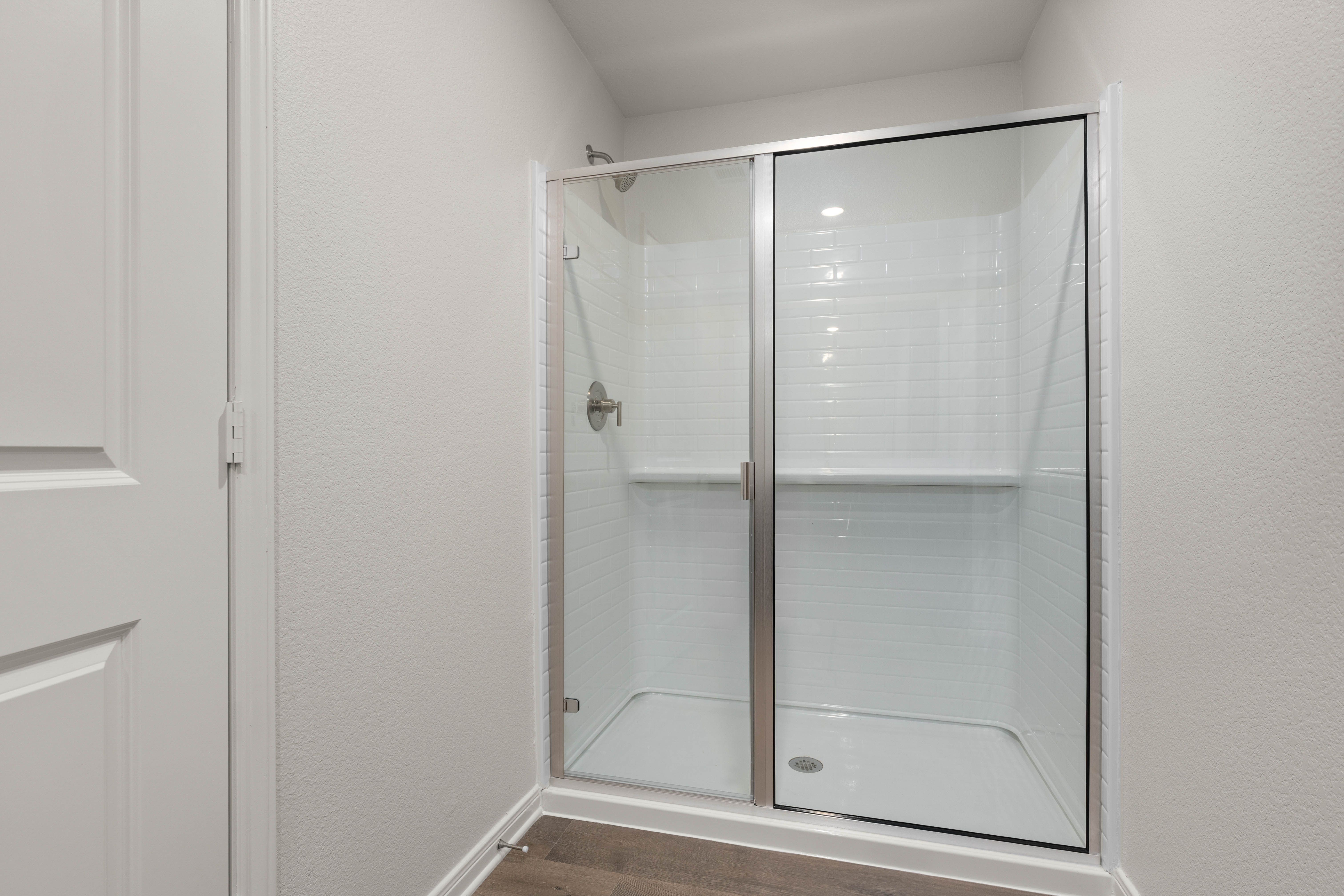 The master bathroom has a glass walk-in shower.