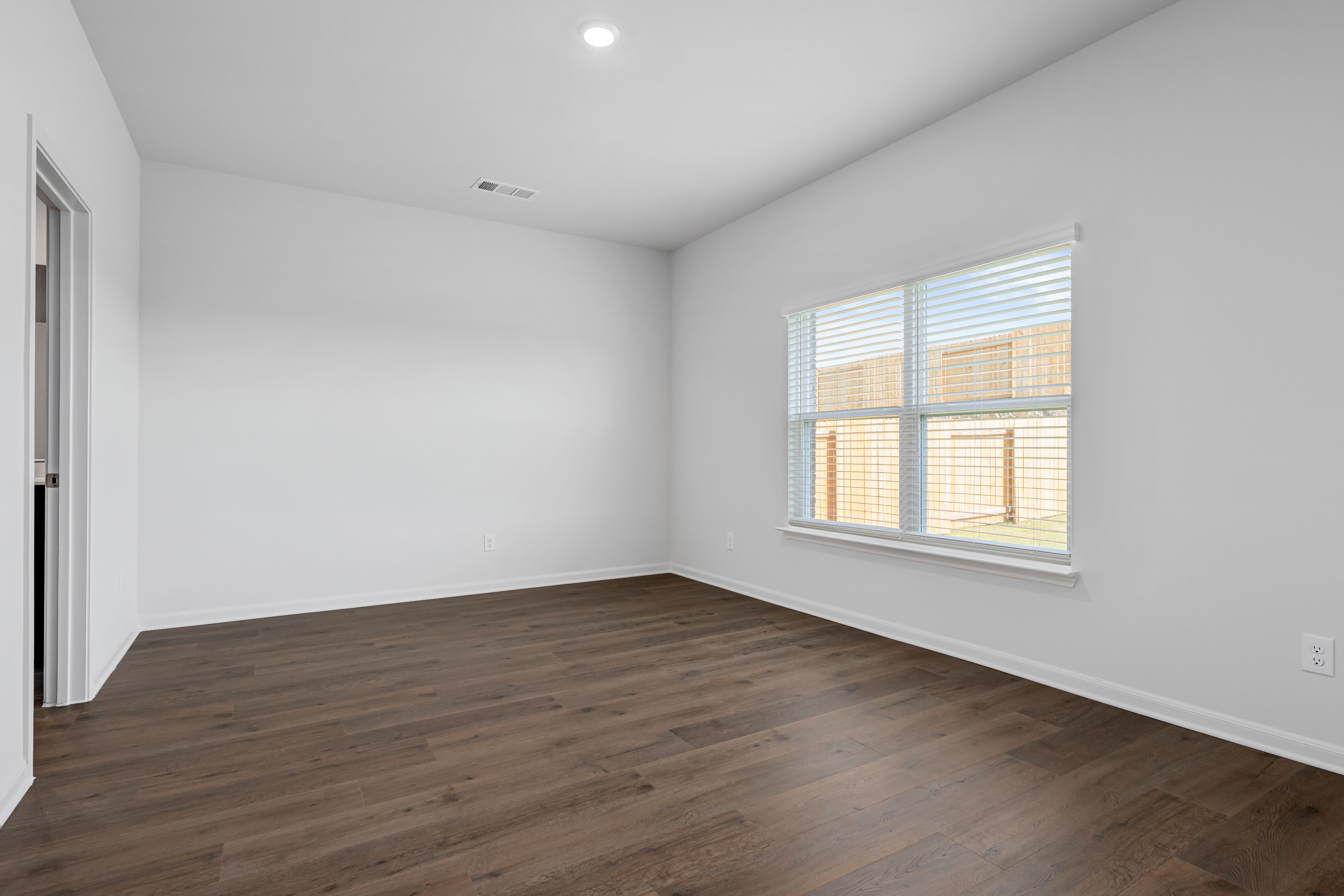 The master bedroom has a large window that lets in great, natural light.
