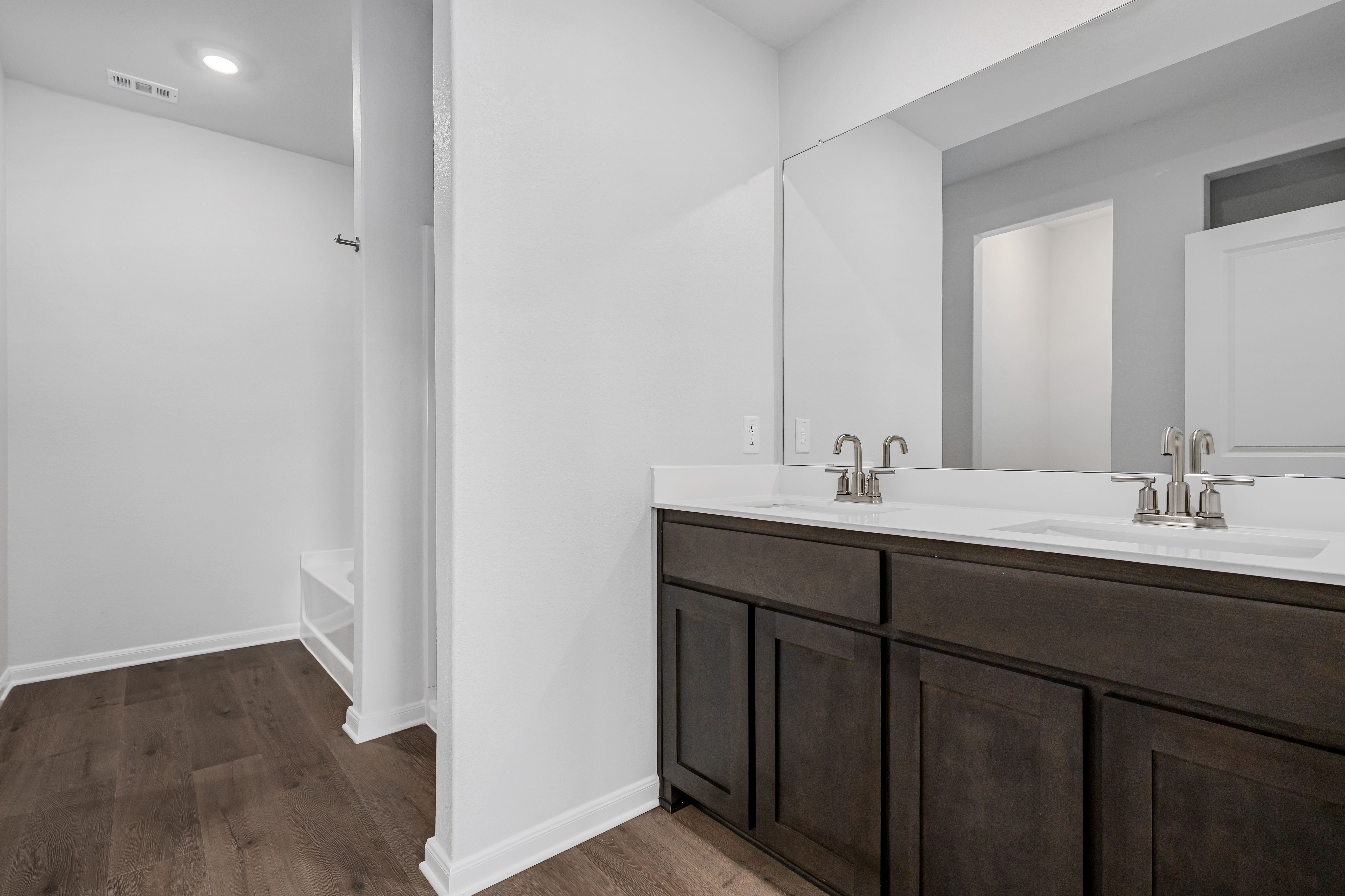 The master bathroom has a sprawling vanity.