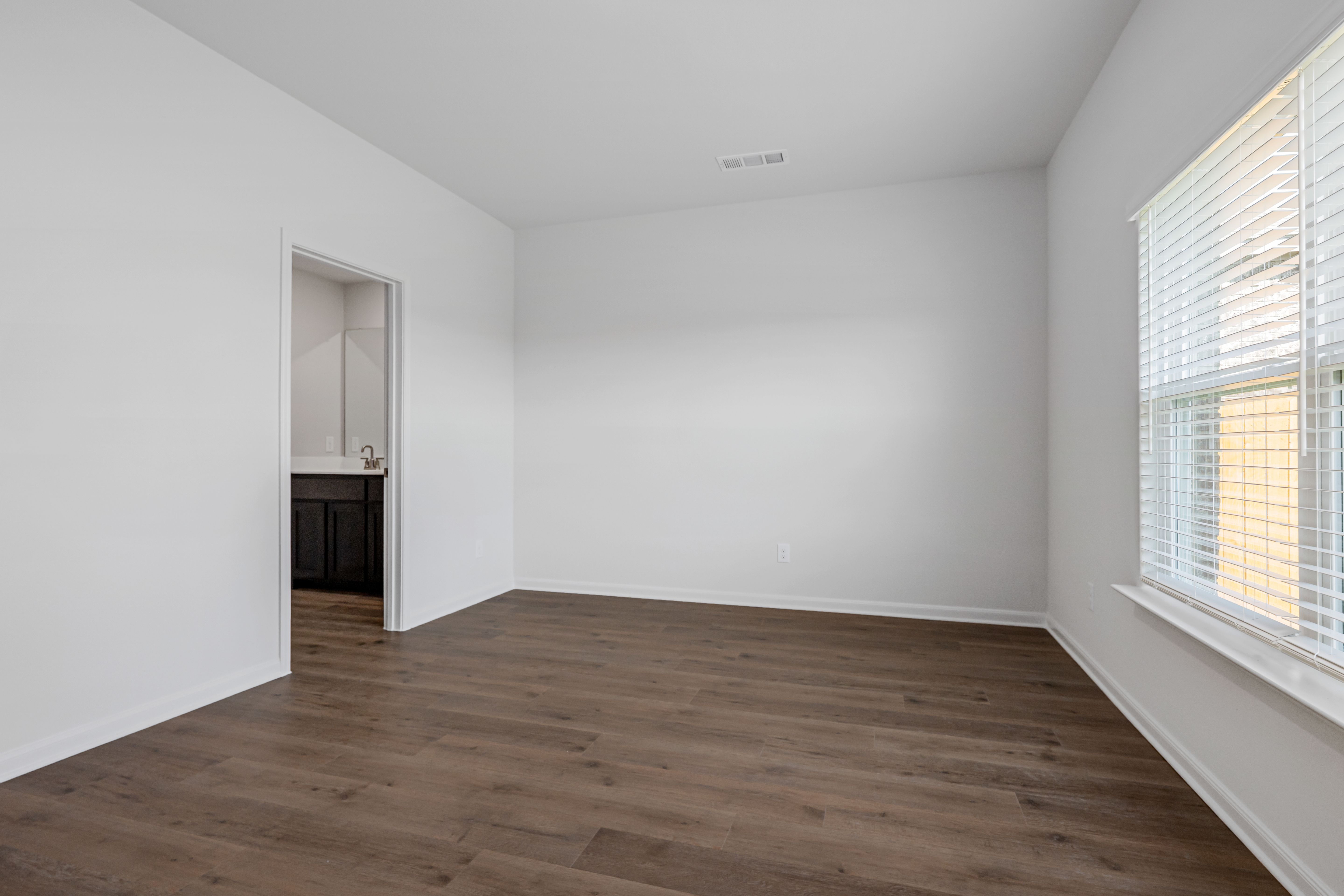 The master suite has a large bedroom, ensuite bathroom and a walk-in closet.