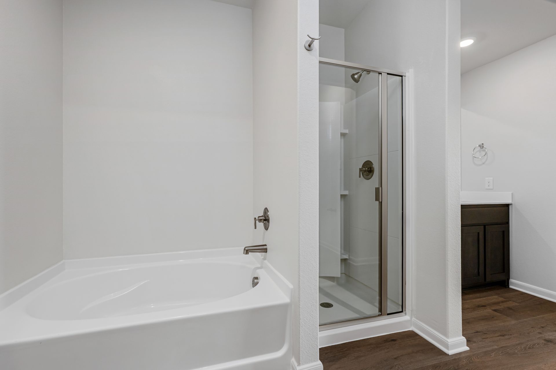 The master bathroom has a garden tub and a glass, walk-in shower.
