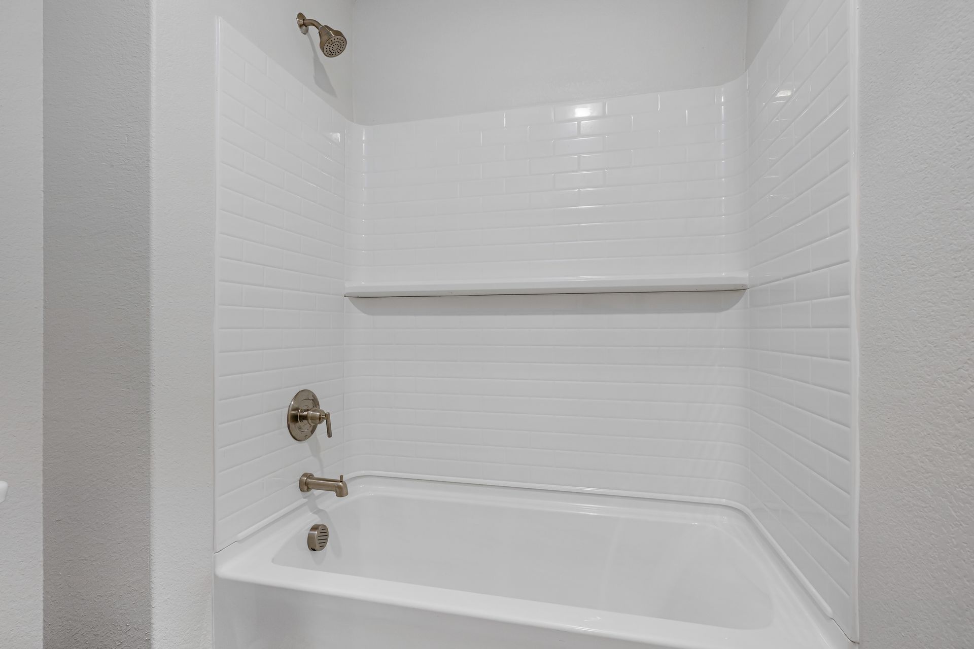 The secondary bathroom has a shower-tub combo.