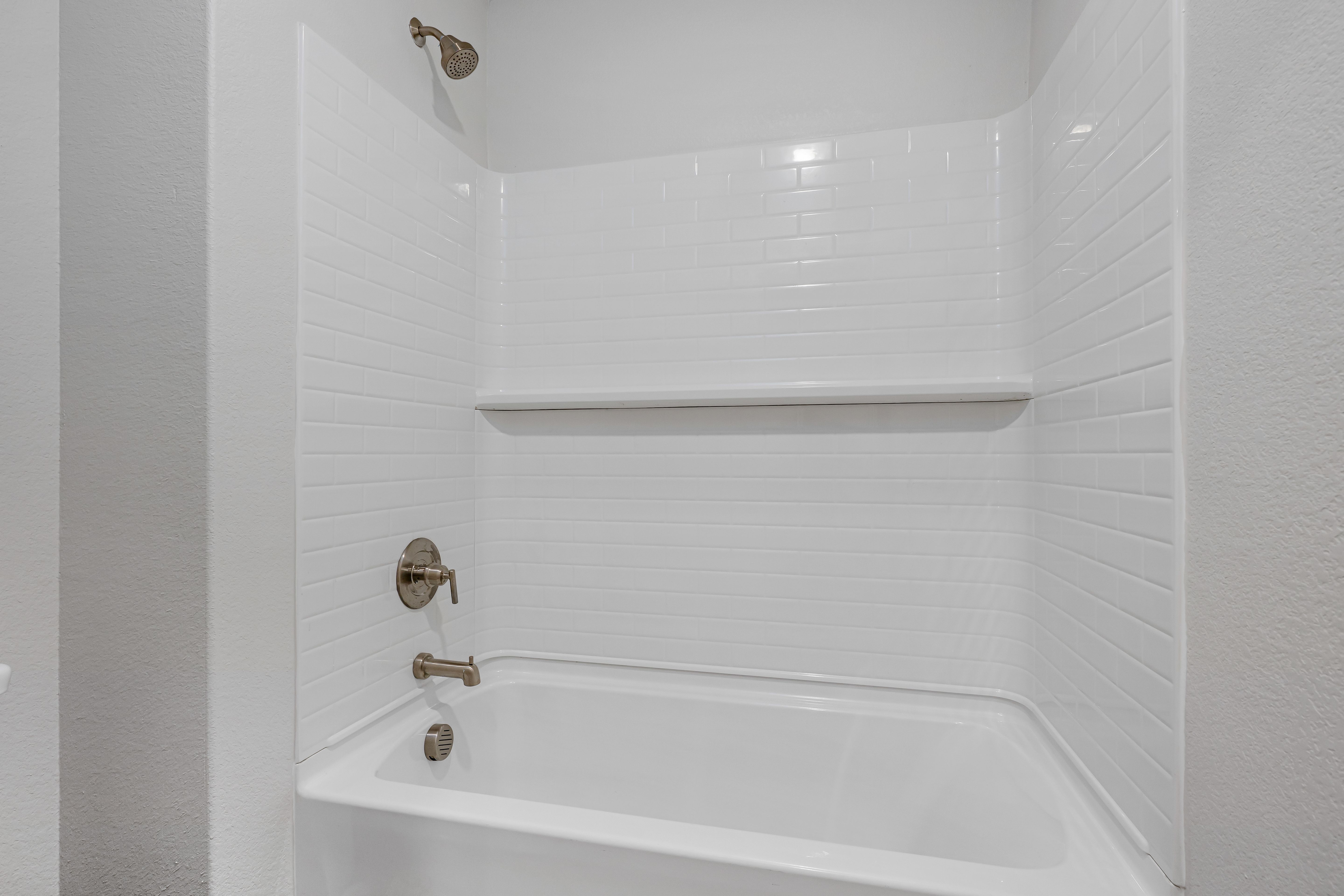 The secondary bathroom has a shower-tub combo.