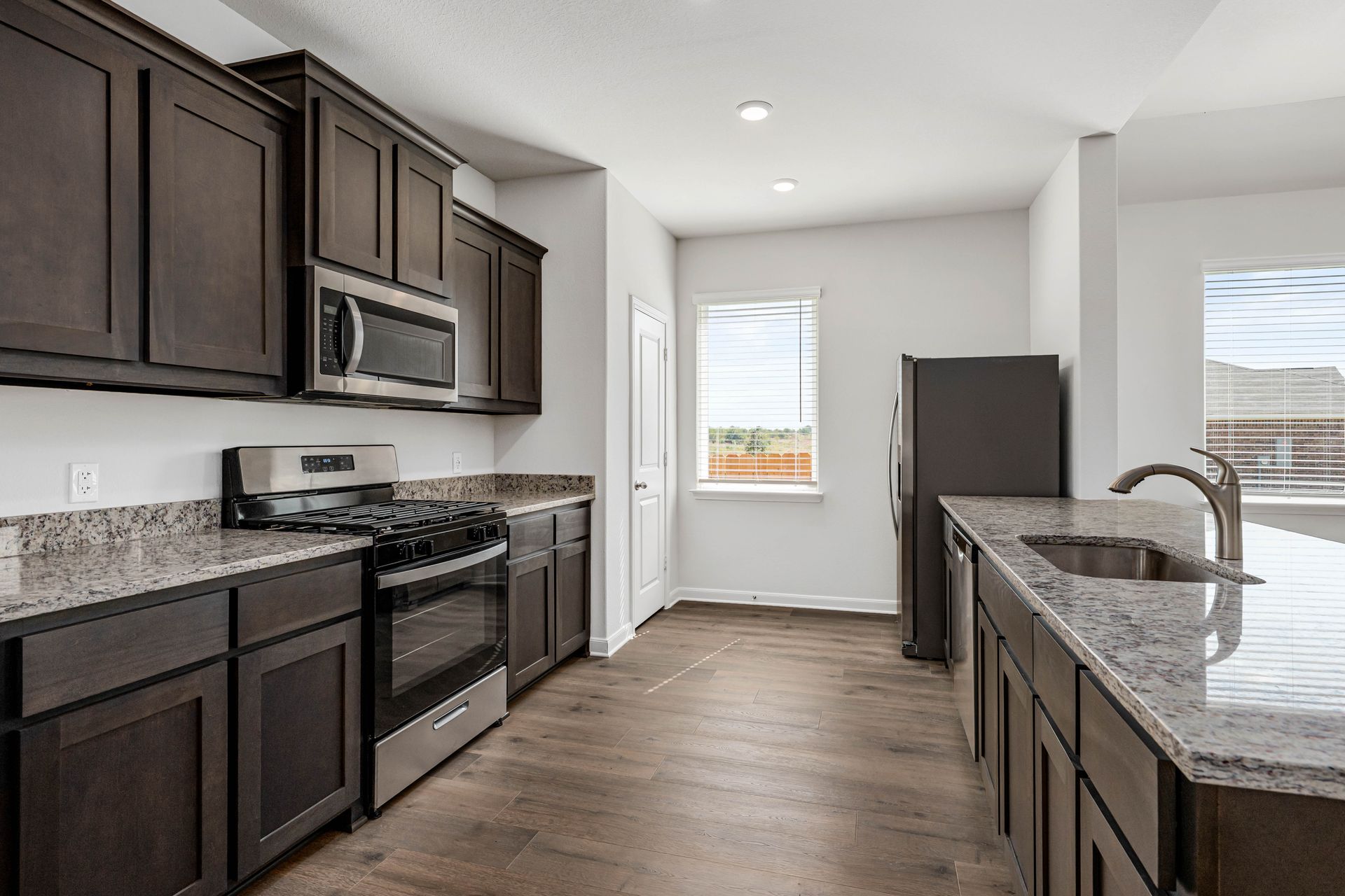 The kitchen has sprawling granite countertops.