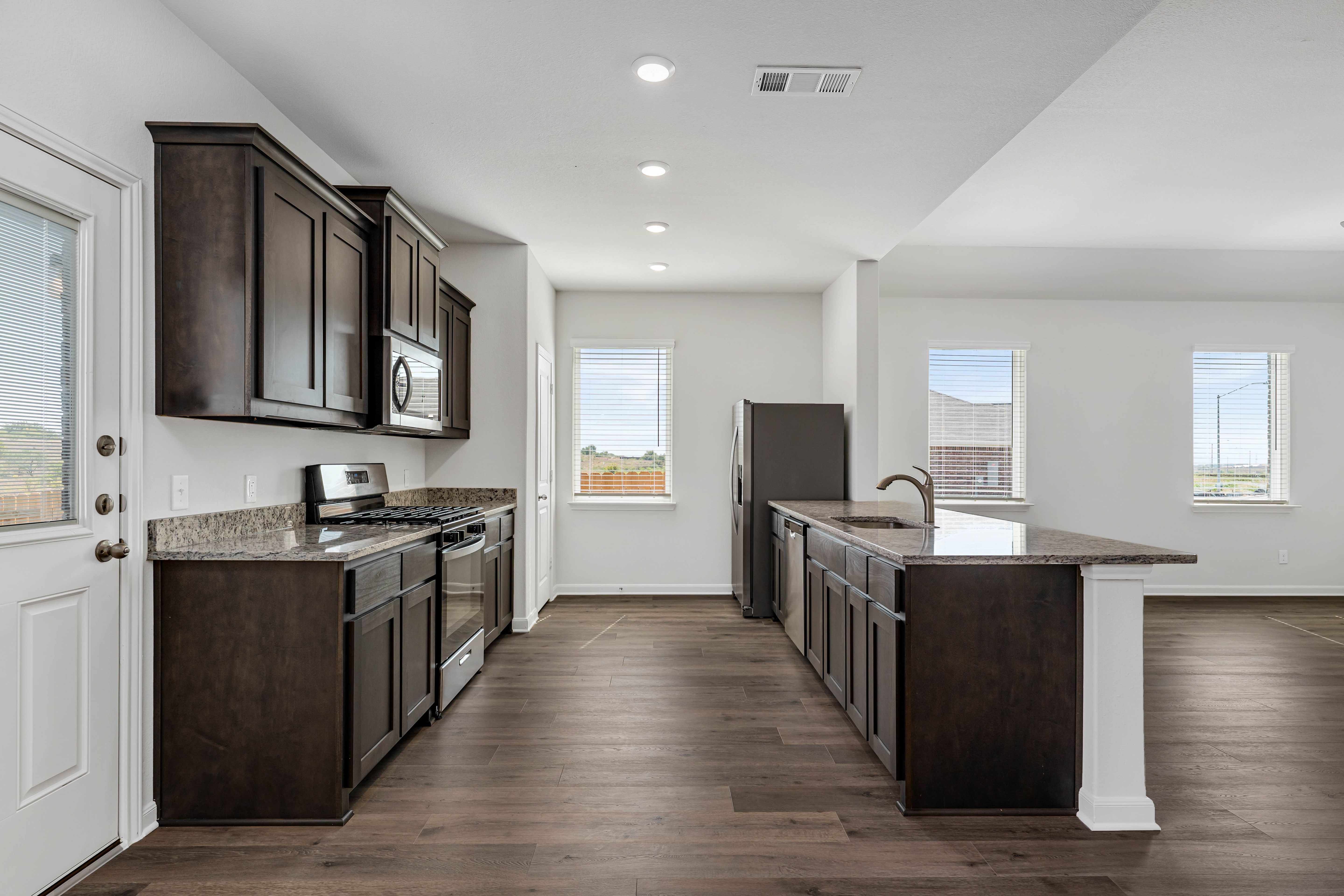 The kitchen has energy-efficient, stainless-steel appliances.