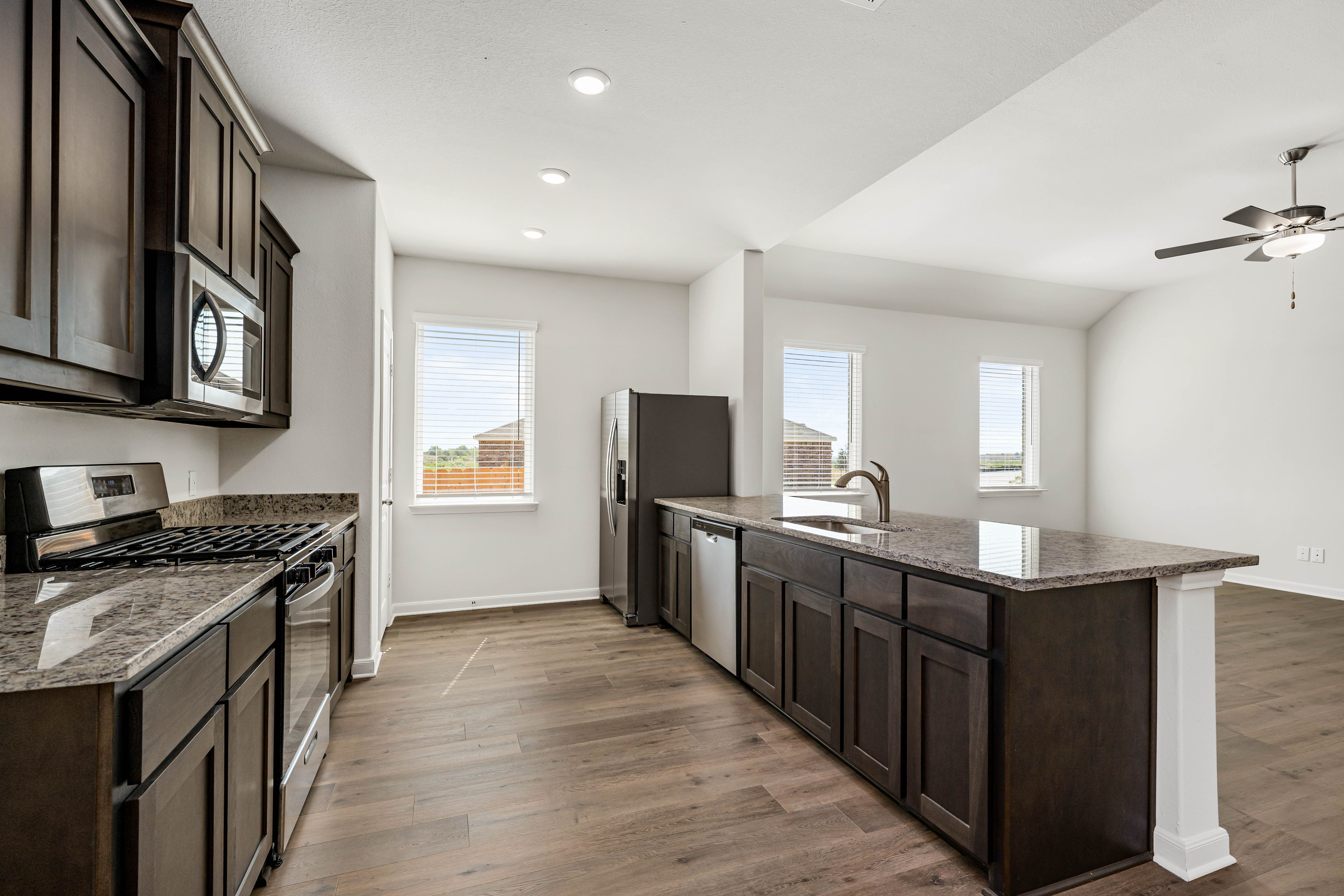 The kitchen has beautiful wood cabinetry.