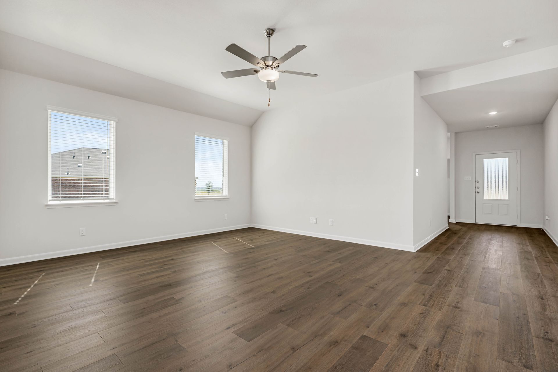 The living room has large windows that let in great, natural light.