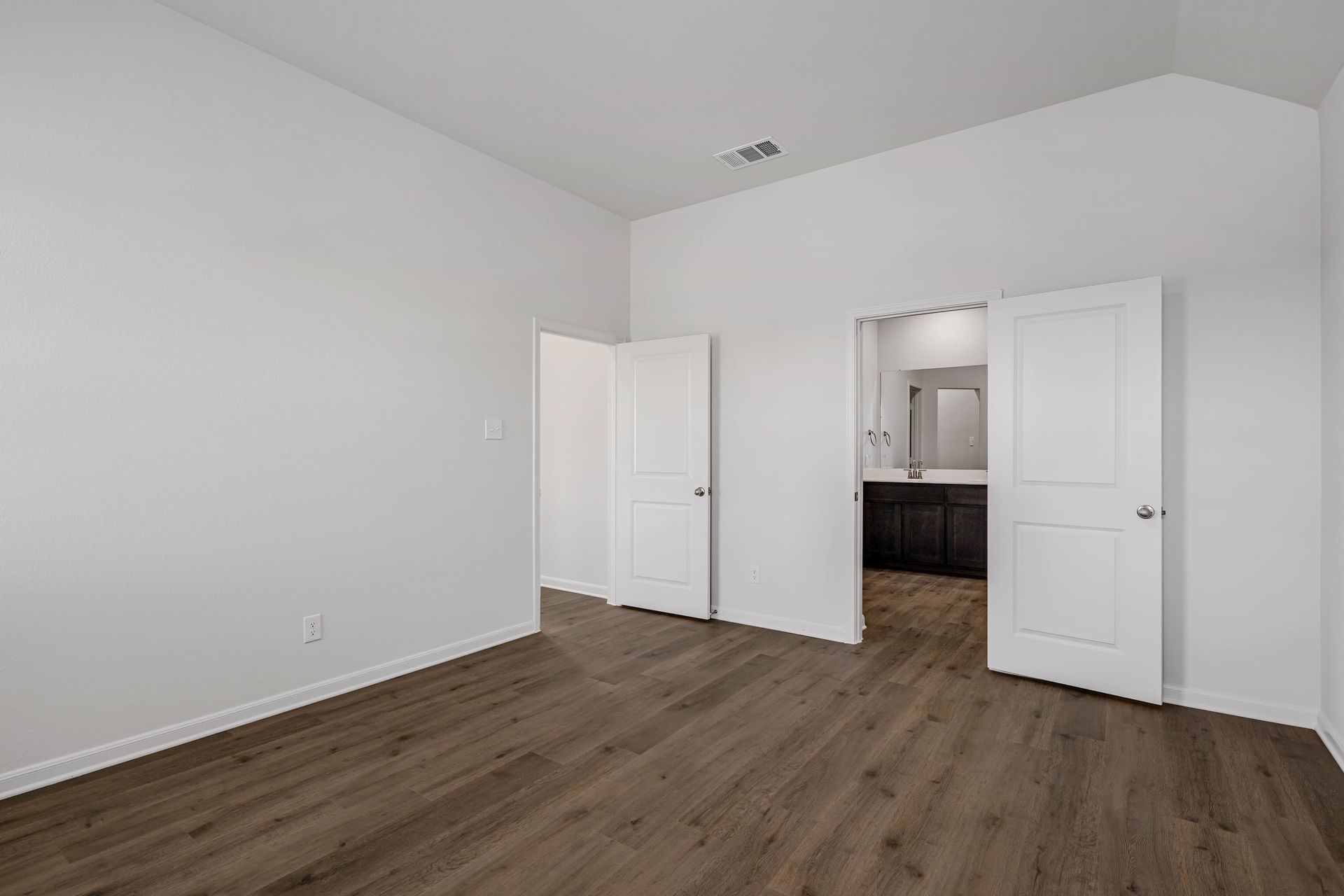 The master suite has a large bedroom, ensuite bathroom and a walk-in closet.