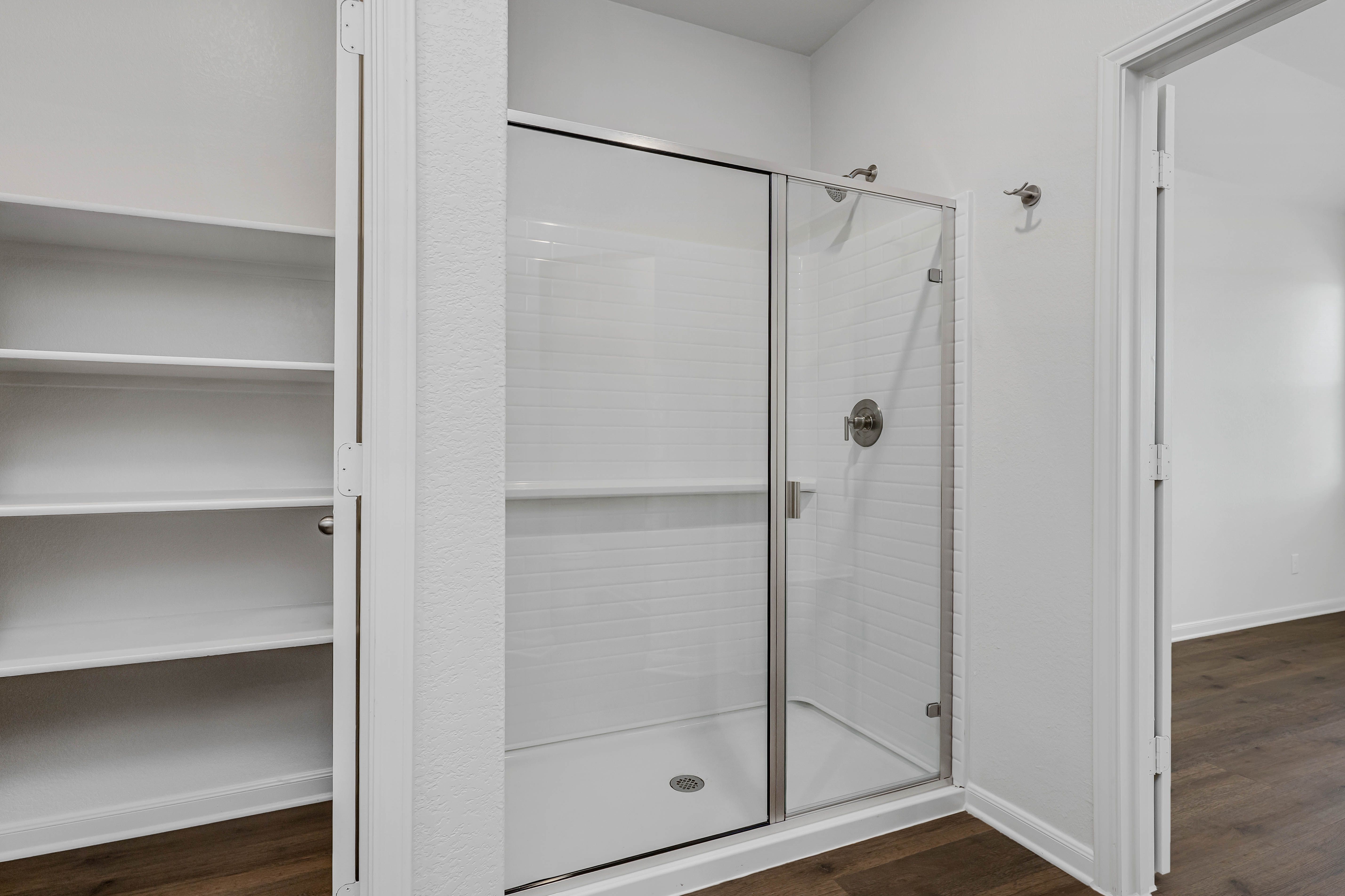 The master bathroom has a garden tub and a glass, walk-in shower.