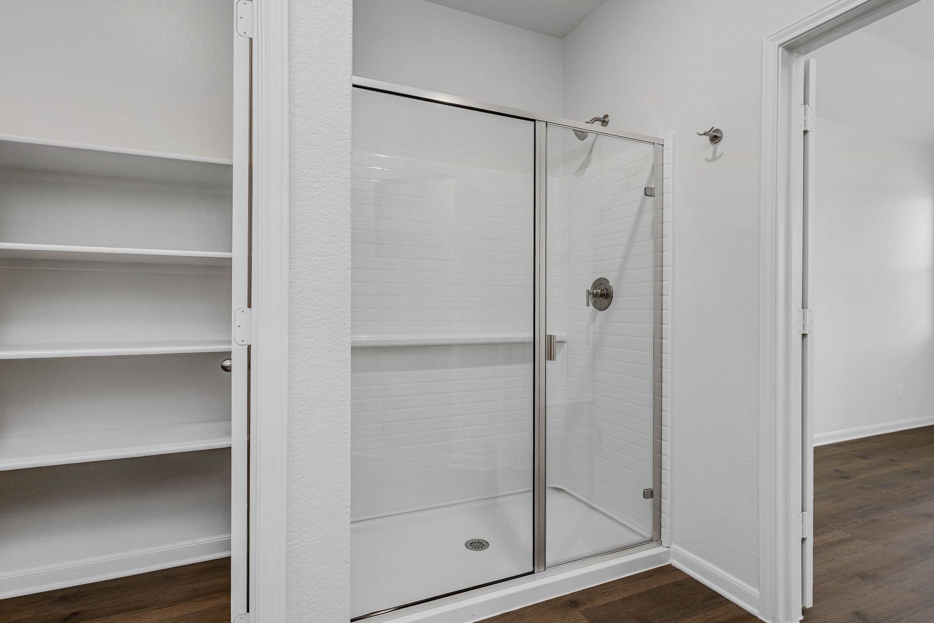 The master bathroom has a garden tub and a glass, walk-in shower.
