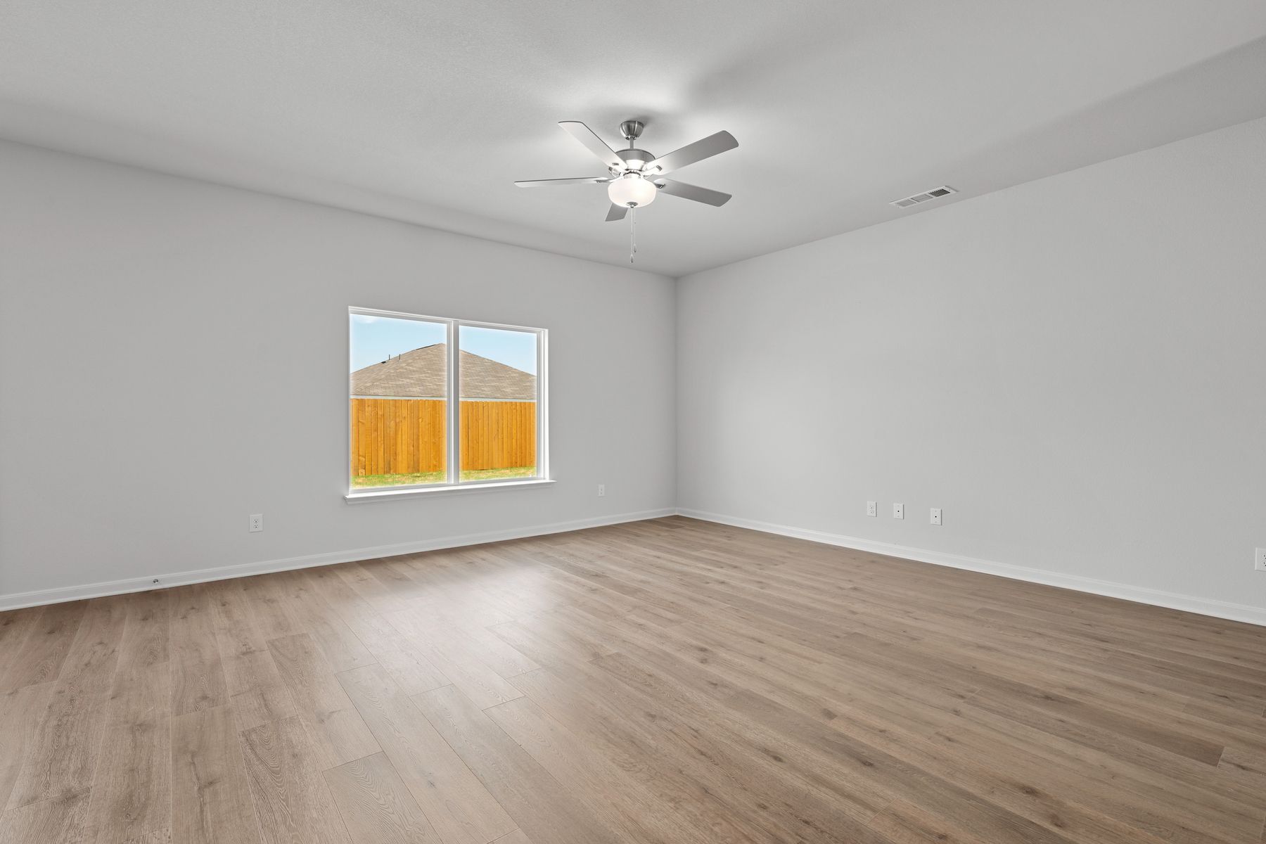 The living room is spacious and has plenty of space for family and friends.