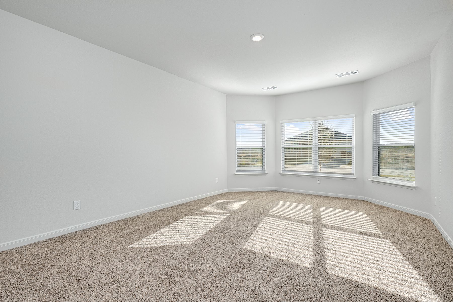 The master bedroom has three large windows that let in great, natural light.