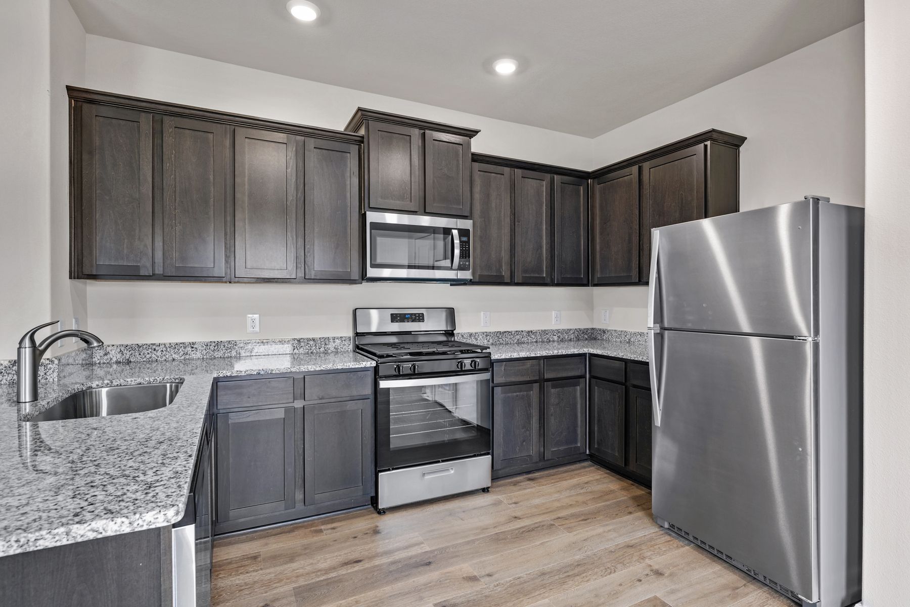 The kitchen has sprawling granite countertops.
