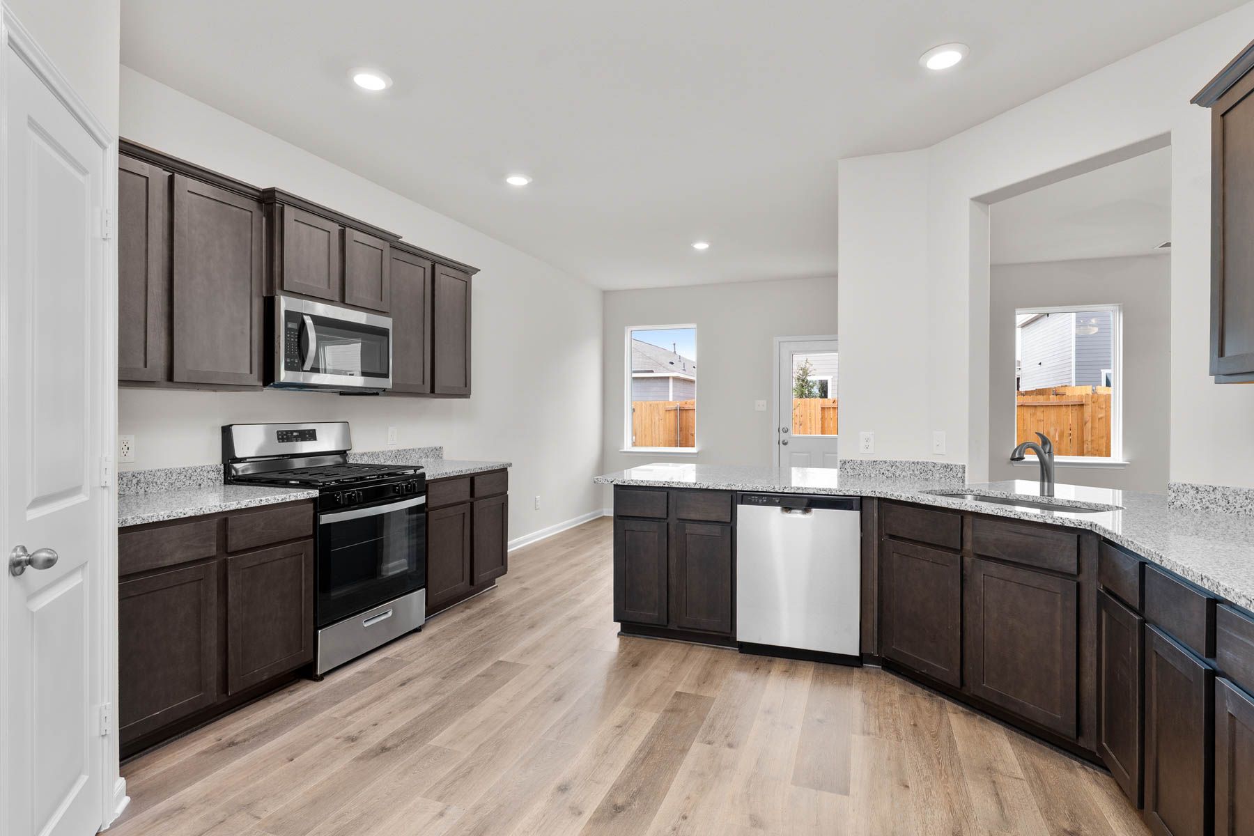 The kitchen has designer wood cabinetry.
