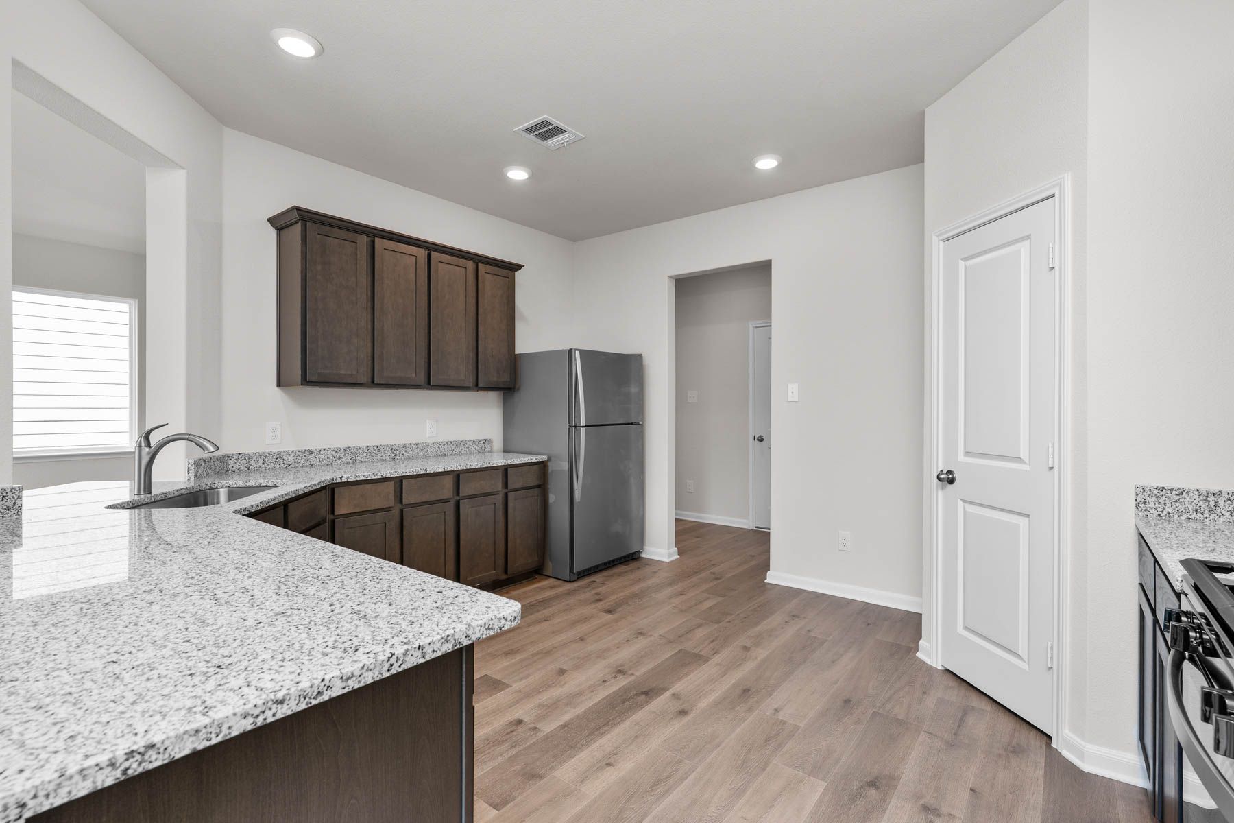 The kitchen has sprawling granite countertops.