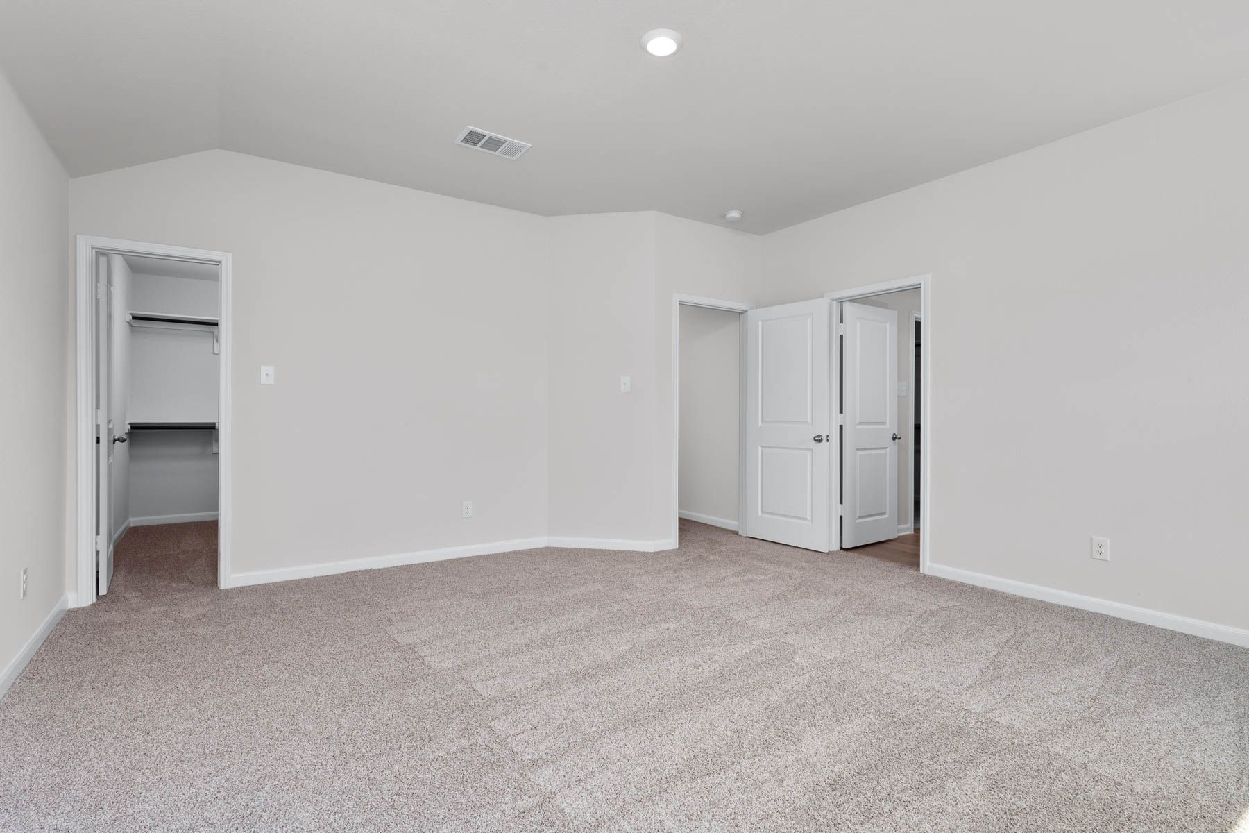 The master suite has a large bedroom, ensuite bathroom and a walk-in closet.