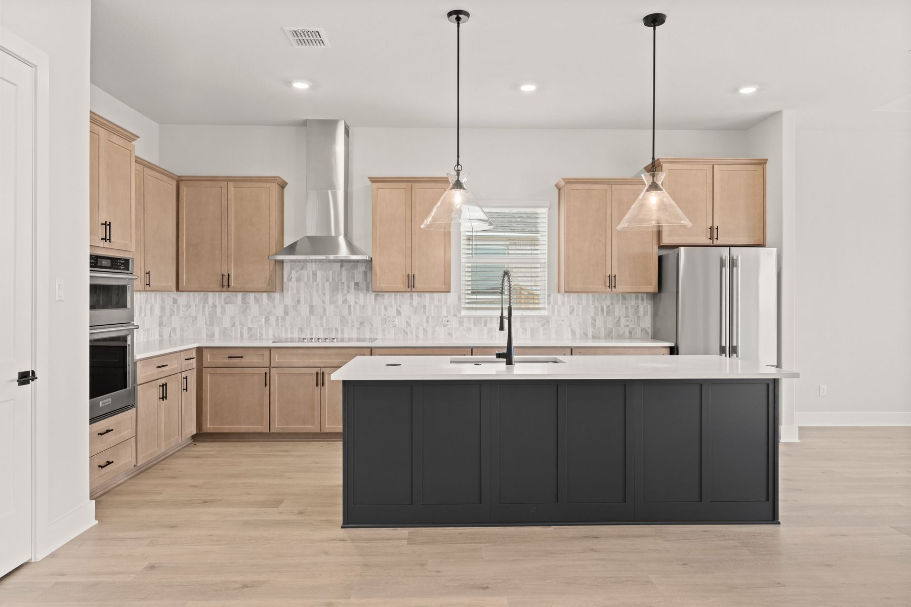 The kitchen has beautiful designer wood cabinetry.