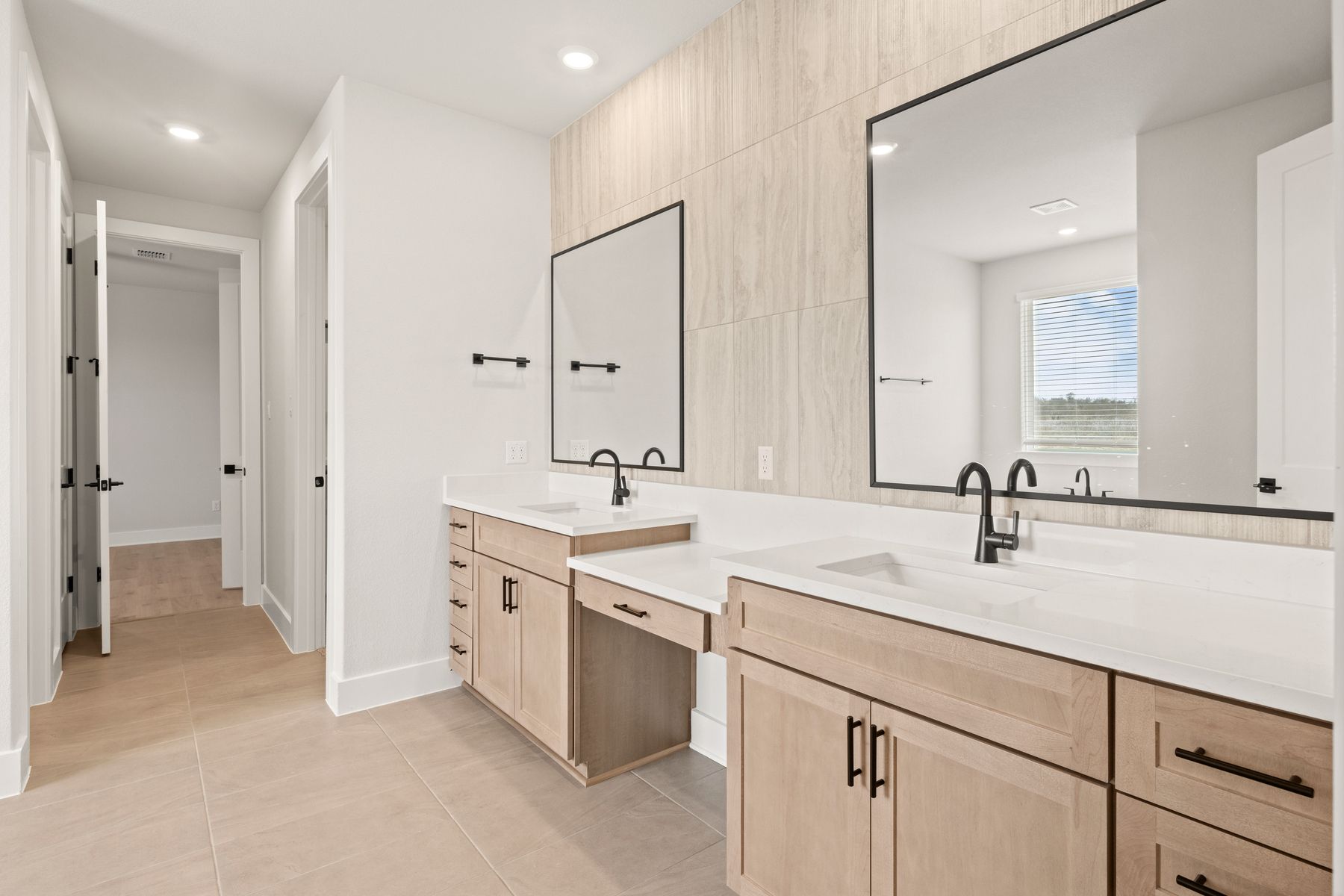 The master bathroom has a dual-sink vanity with a makeup station in between. 