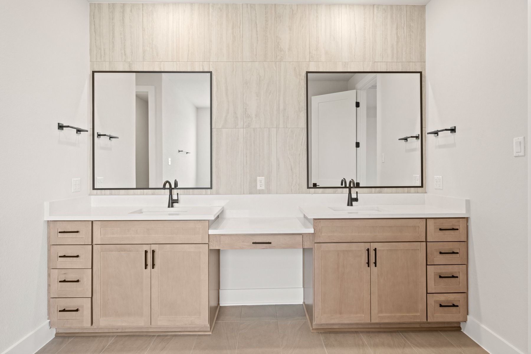The master bathroom has a dual-sink vanity with a makeup station in between. 