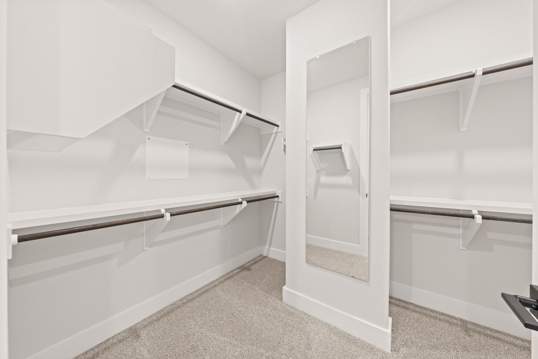 The walk-in, master closet has plenty of hanging and shelf space.
