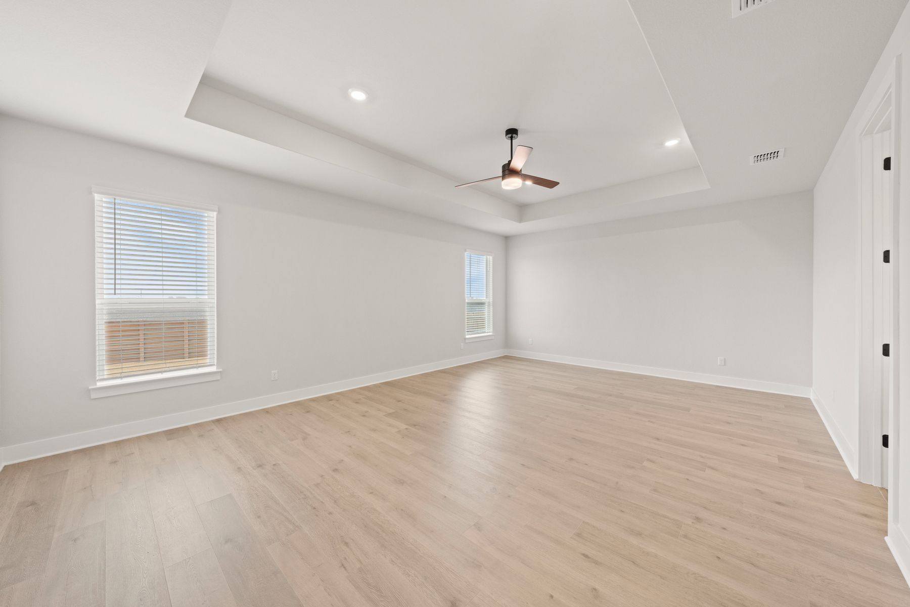 The master bedroom has two large windows that let in great, natural light.