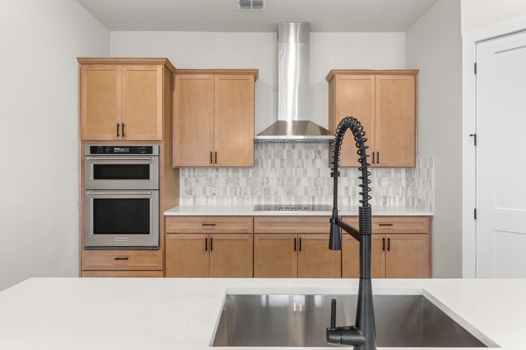 The kitchen has sprawling quartz countertops.