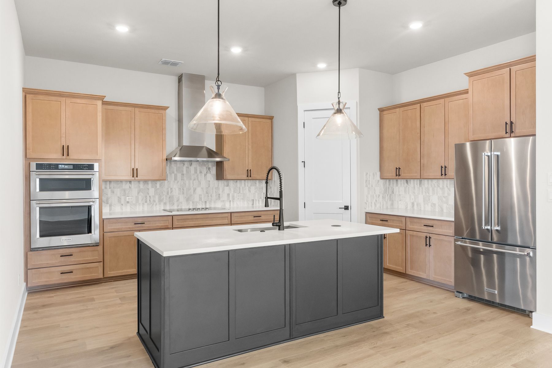 The kitchen has beautiful designer wood cabinetry.
