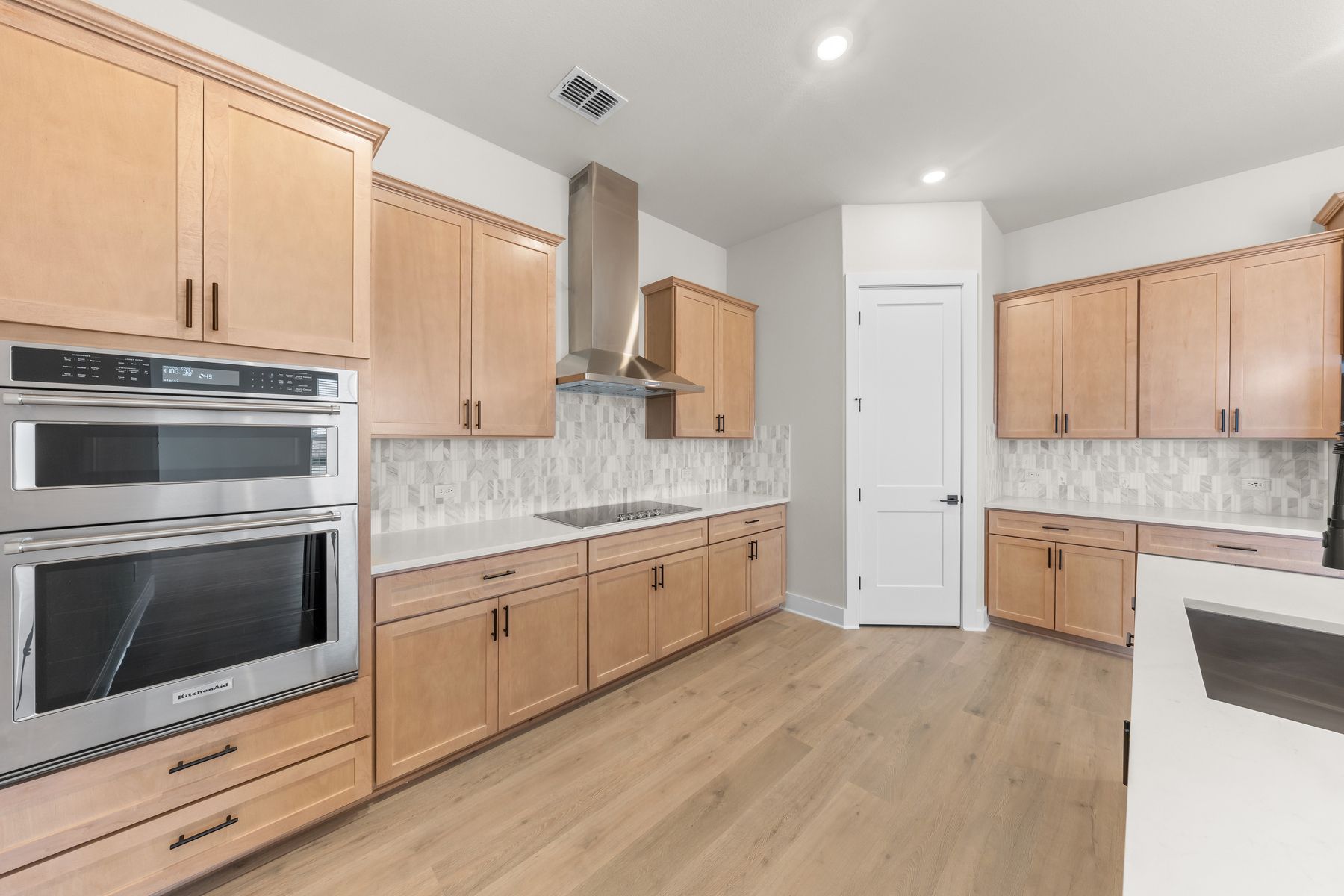 The kitchen has lots of cabinet space and a walk-in pantry that provides ample storage.
