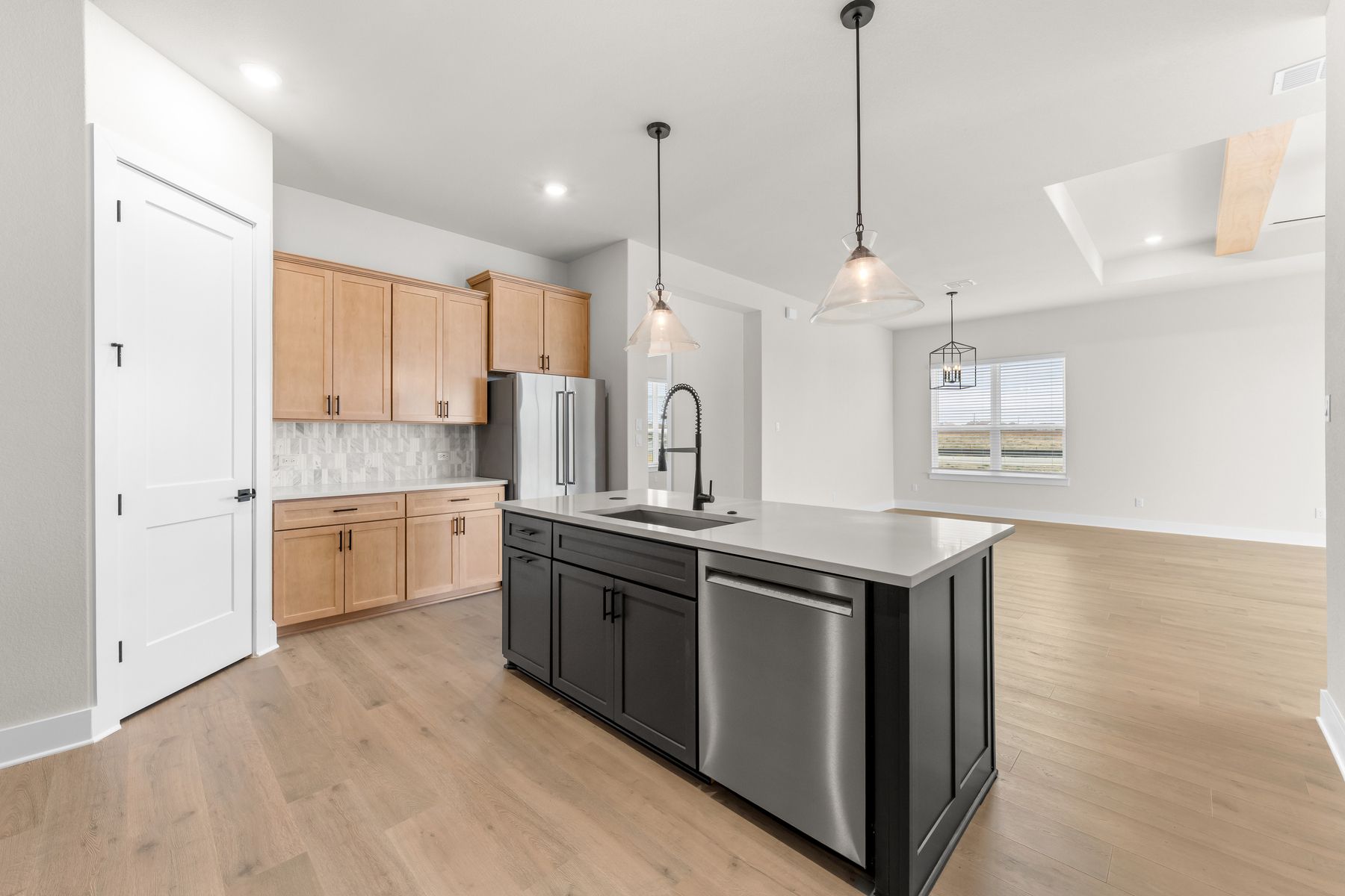 The kitchen looks out into the dining area and living room.