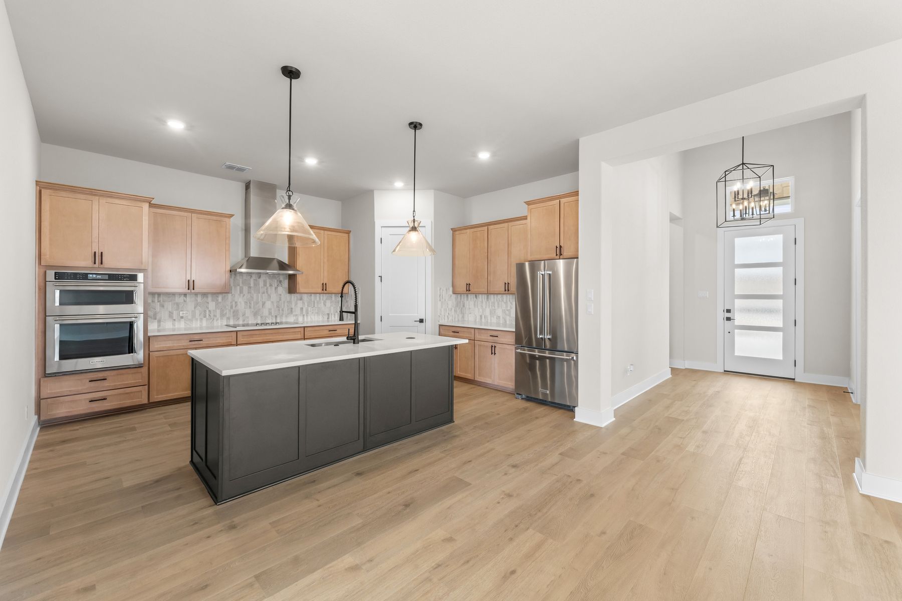The welcoming foyers leads into the open living spaces.