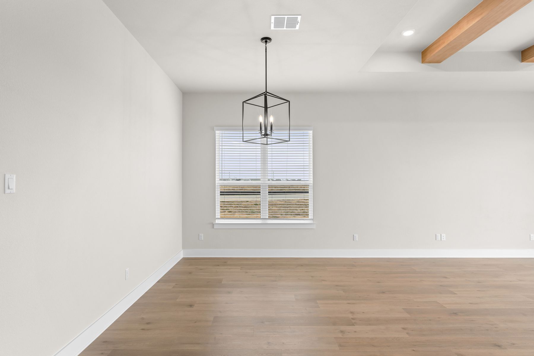 The open dining area has a large window that lets in great, natural light.