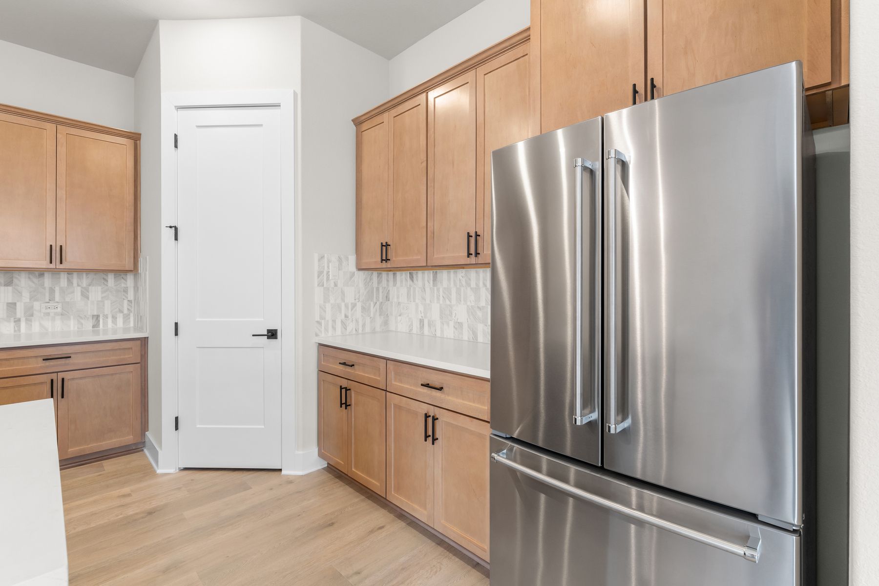 The kitchen has a double door refridgerator with a freezer drawer.
