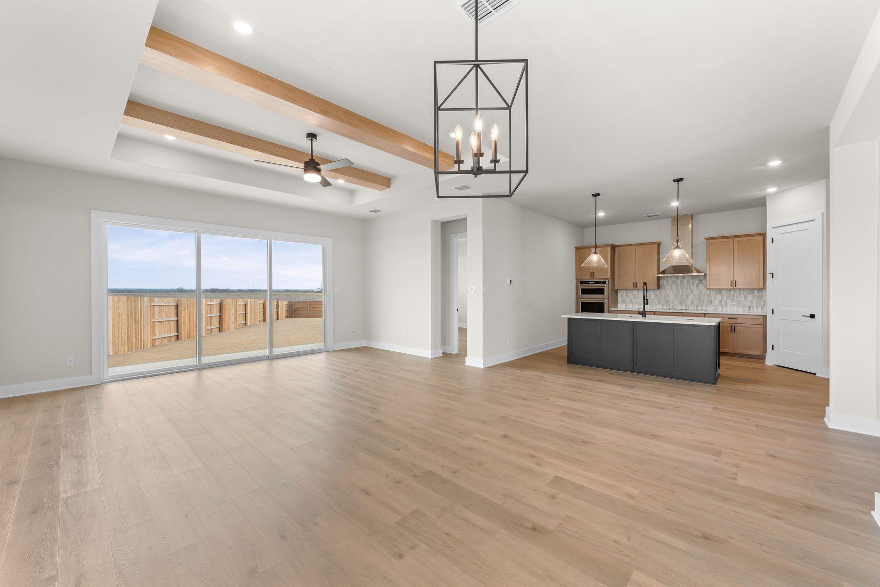The open layout connects the kitchen, dining area and living room.