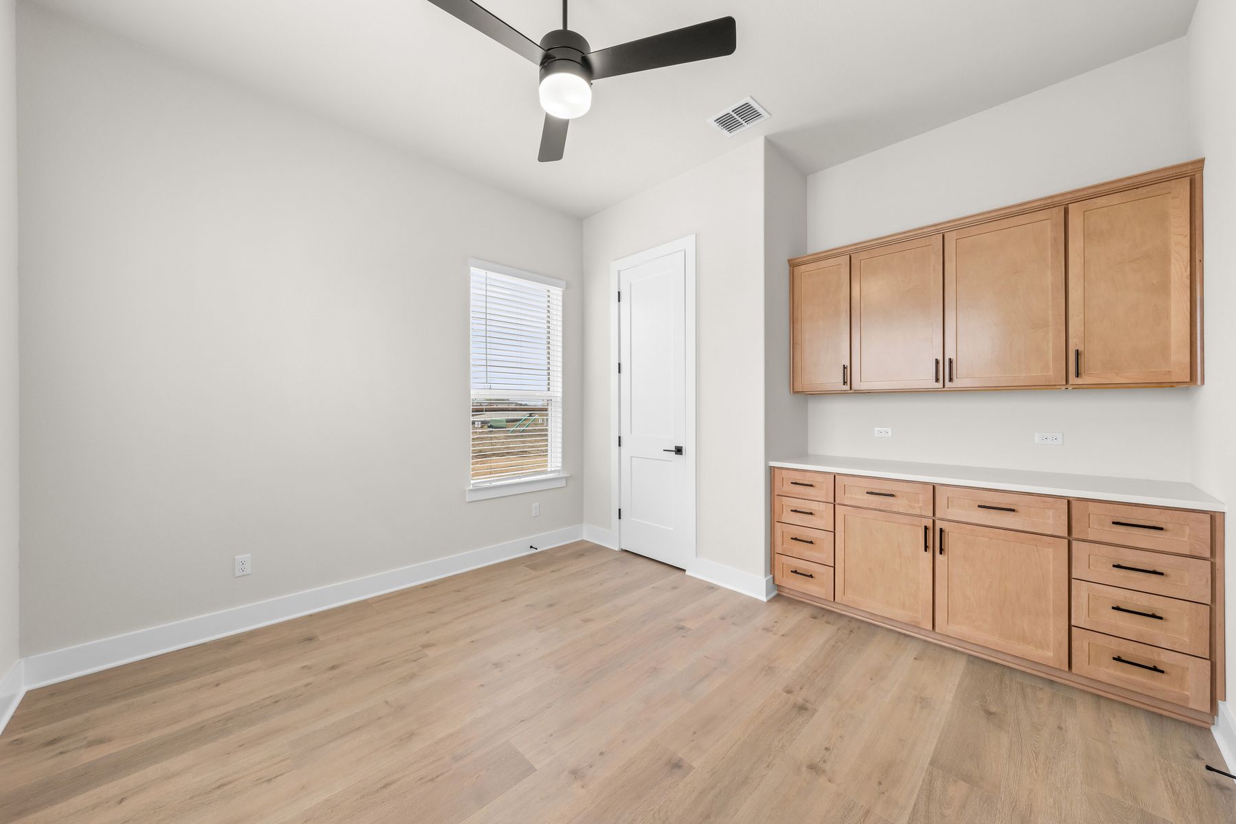The flex room has a beautiful cabinet space for additional storage.