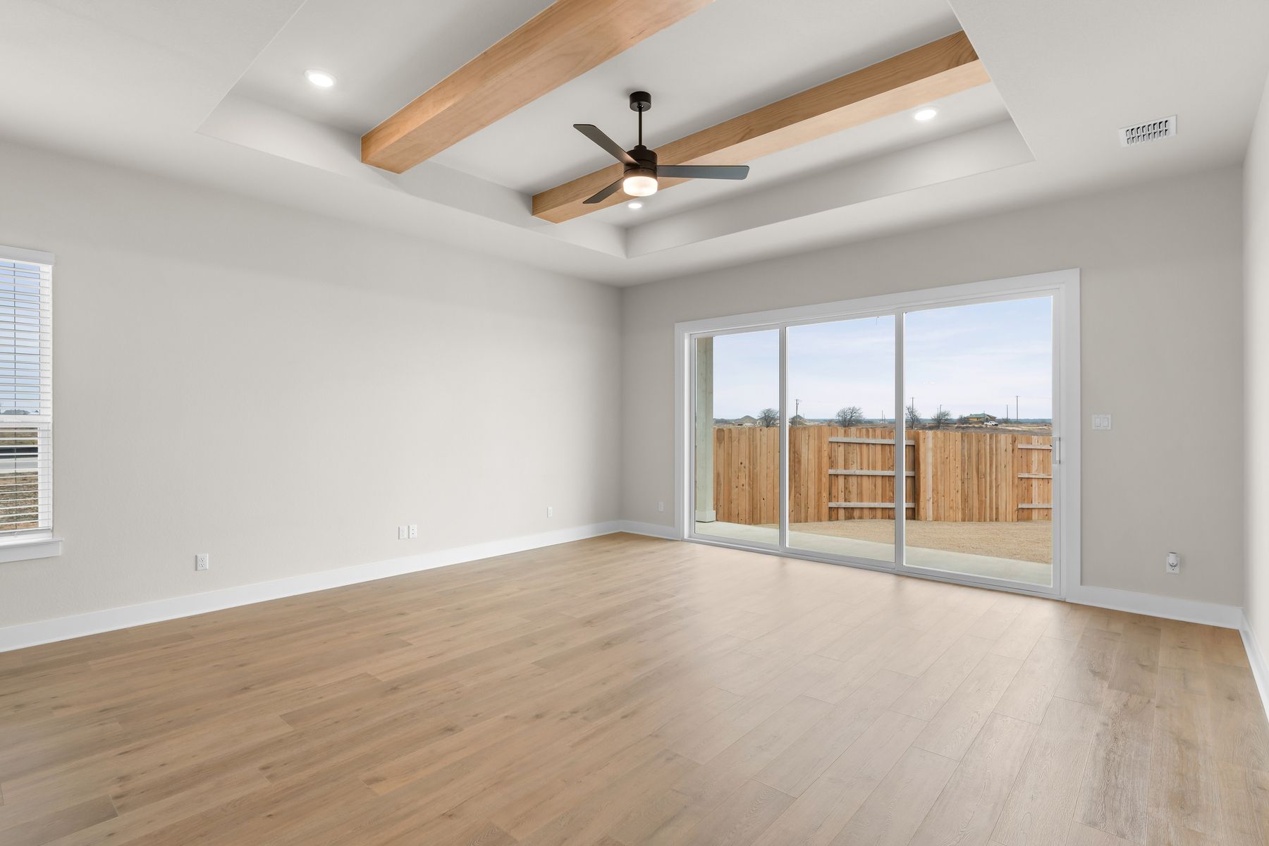 The living room has large windows that let in great, natural light.