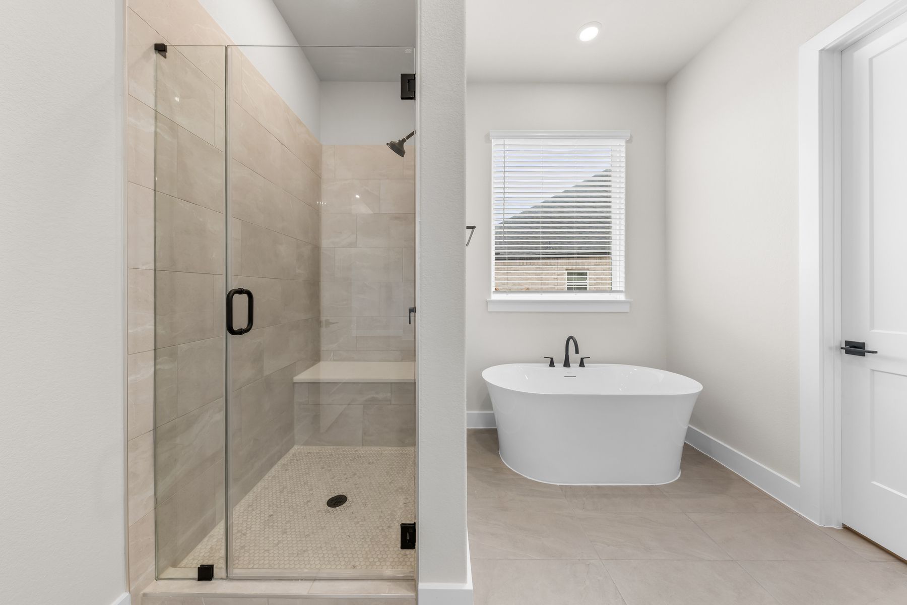 The master bathroom has a glass, walk-in shower and garden tub.