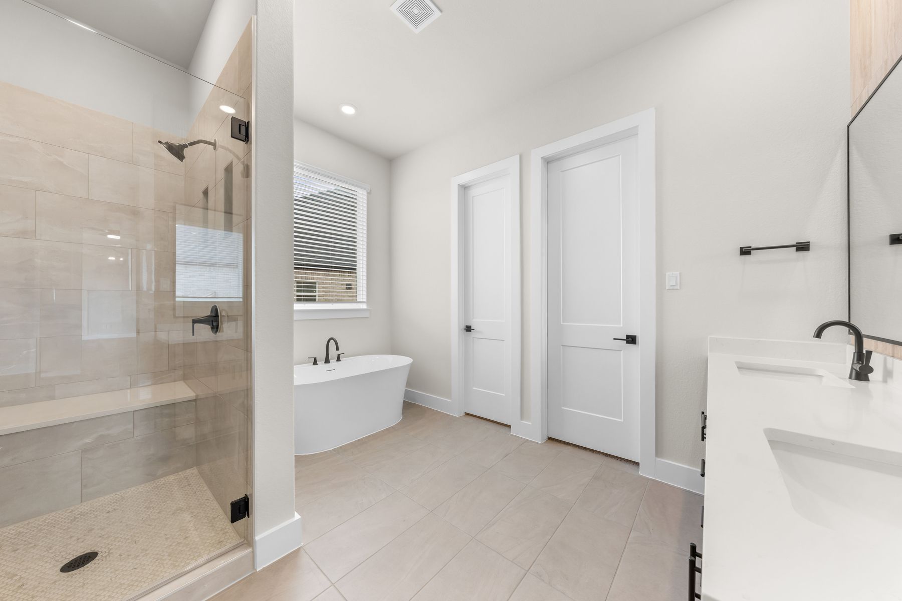 The master bathroom has a glass, walk-in shower and garden tub.