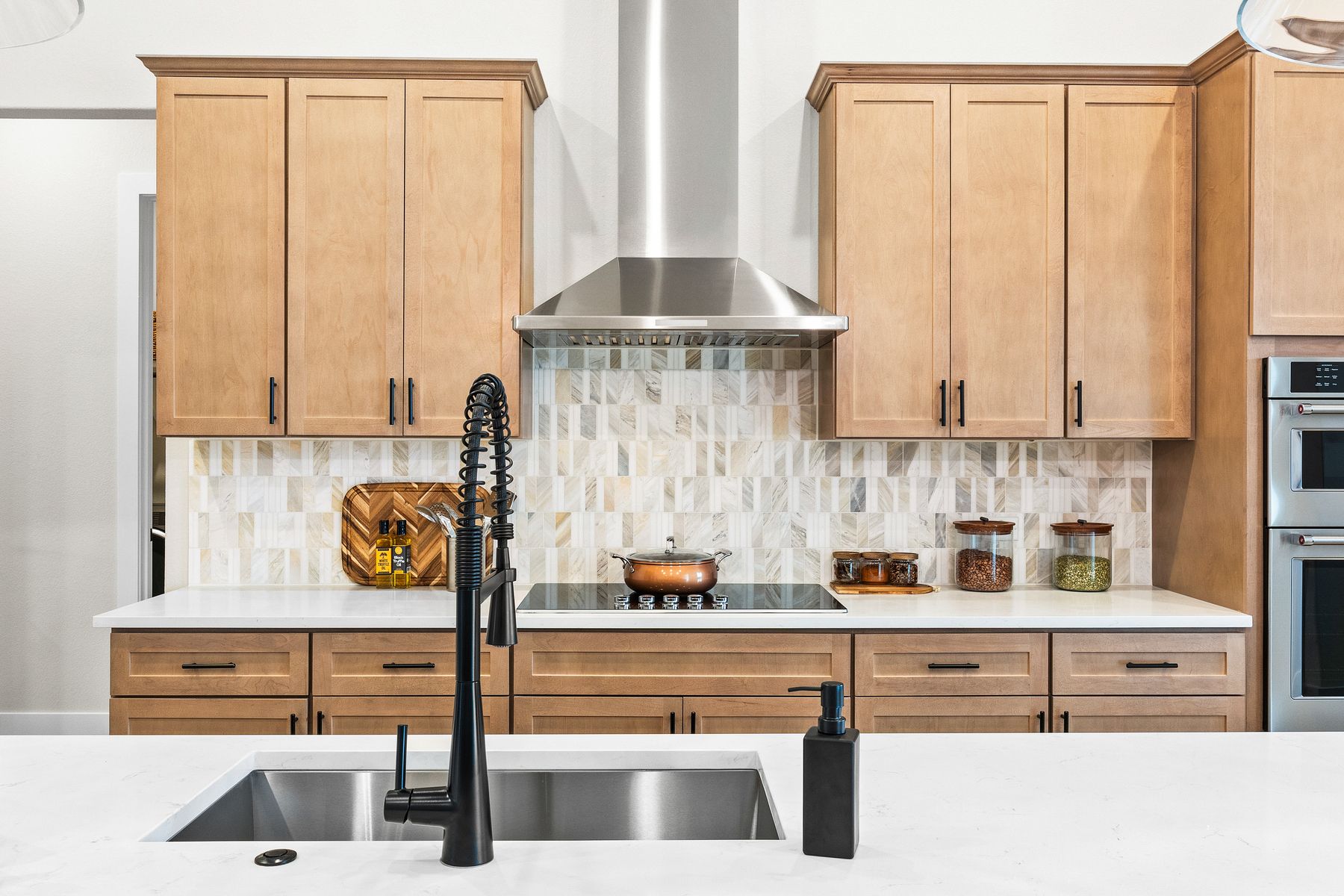 The kitchen has a beautiful tile backsplash.