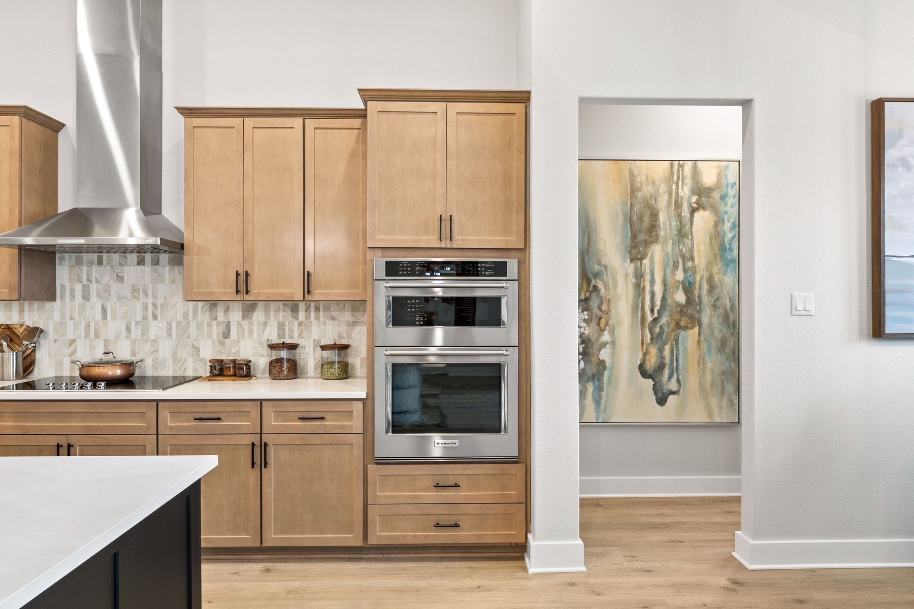 The kitchen has a stacked microwave and oven wall.