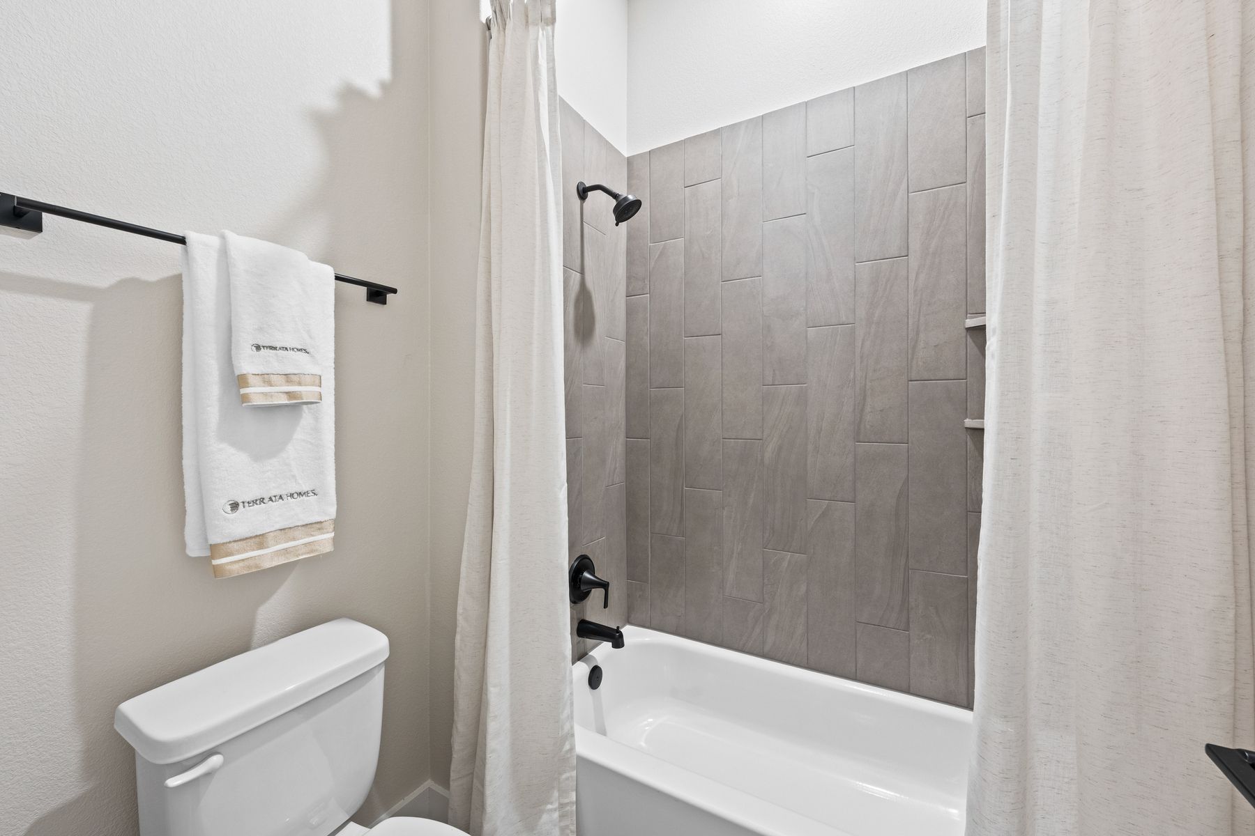 The secondary bathroom has a shower-tub combo.