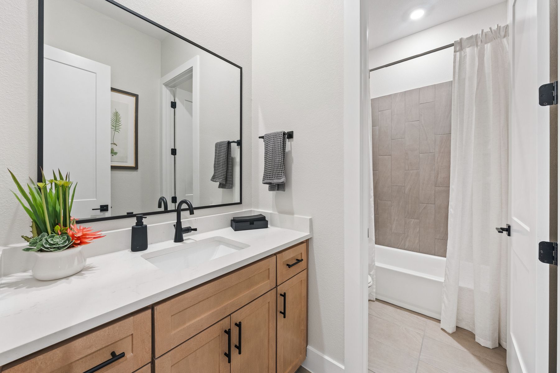The secondary bathroom has an extended vanity space.