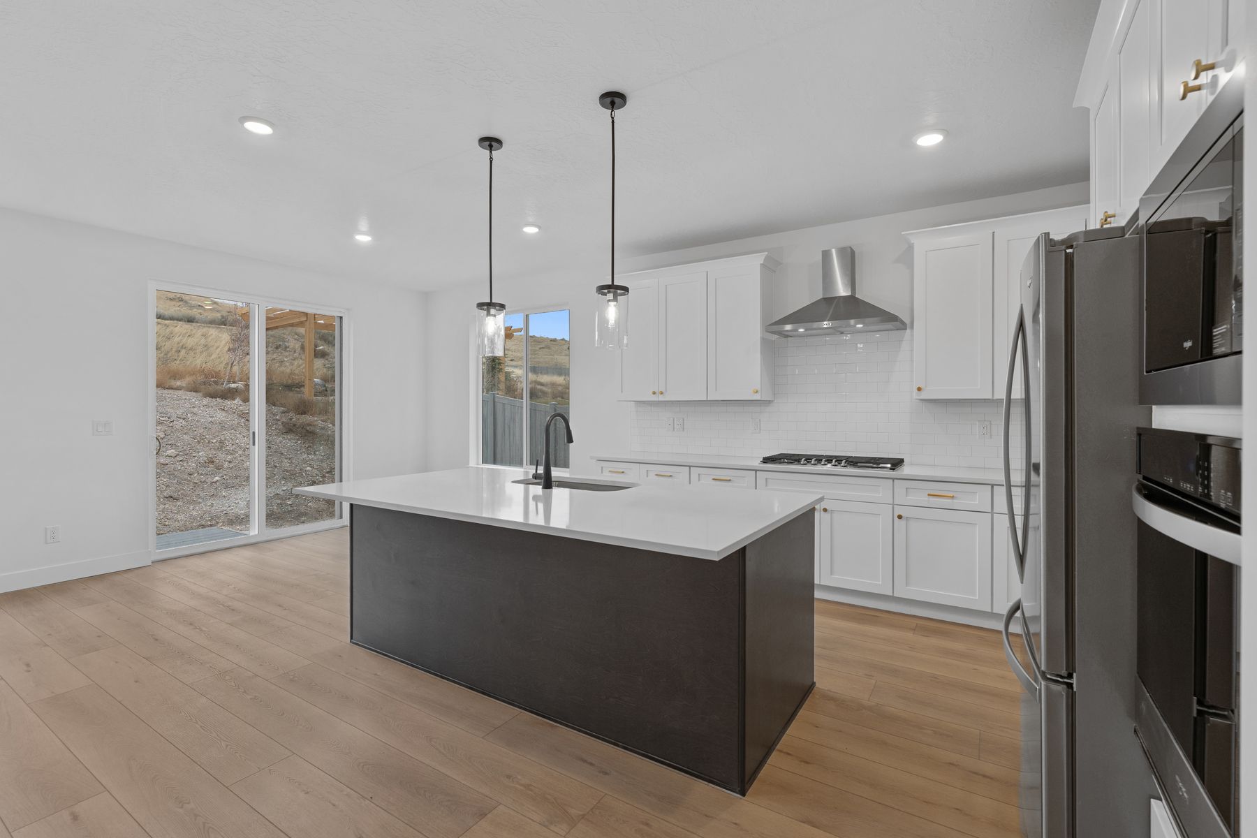The kitchen has a beautiful matte black Moen faucet.